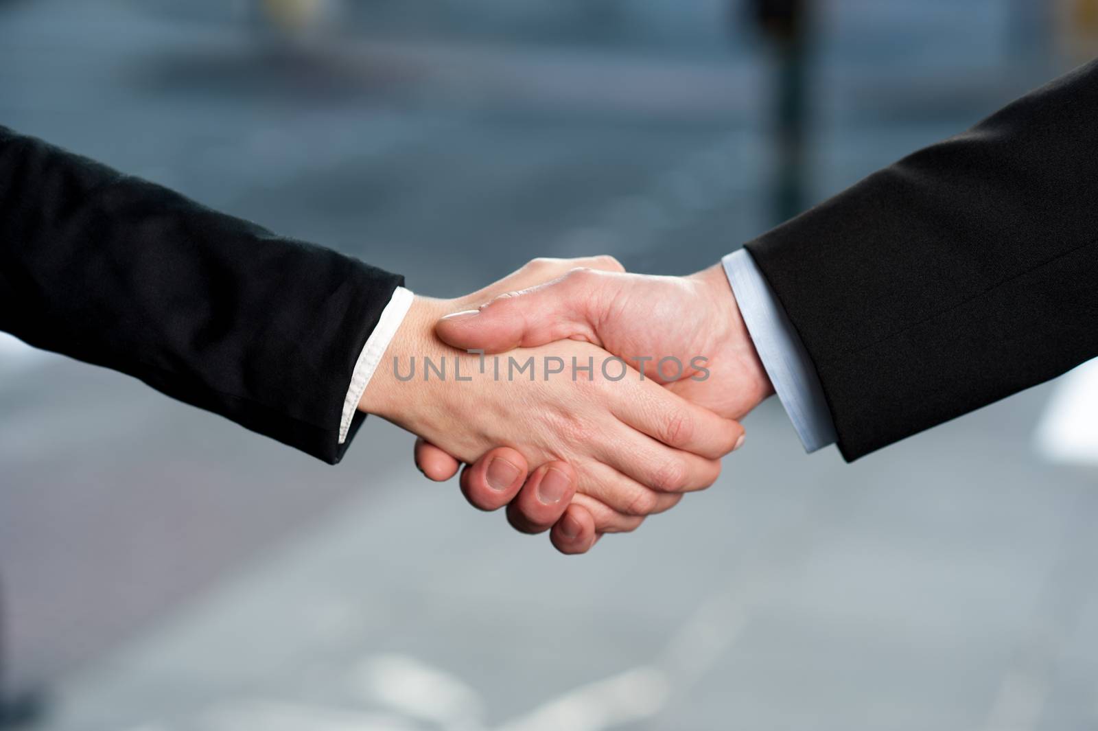 Successful business people shaking hands after closing a deal.