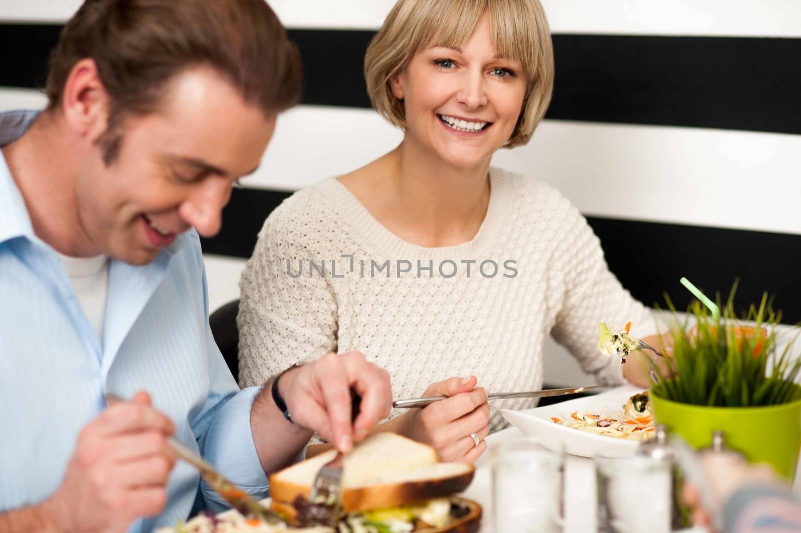 Couple enjoying breakfast in restaurant by stockyimages
