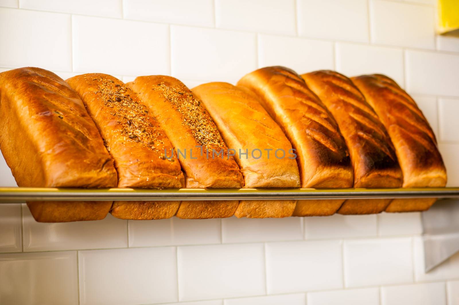 Freshly kneaded grain and white breads for sale by stockyimages