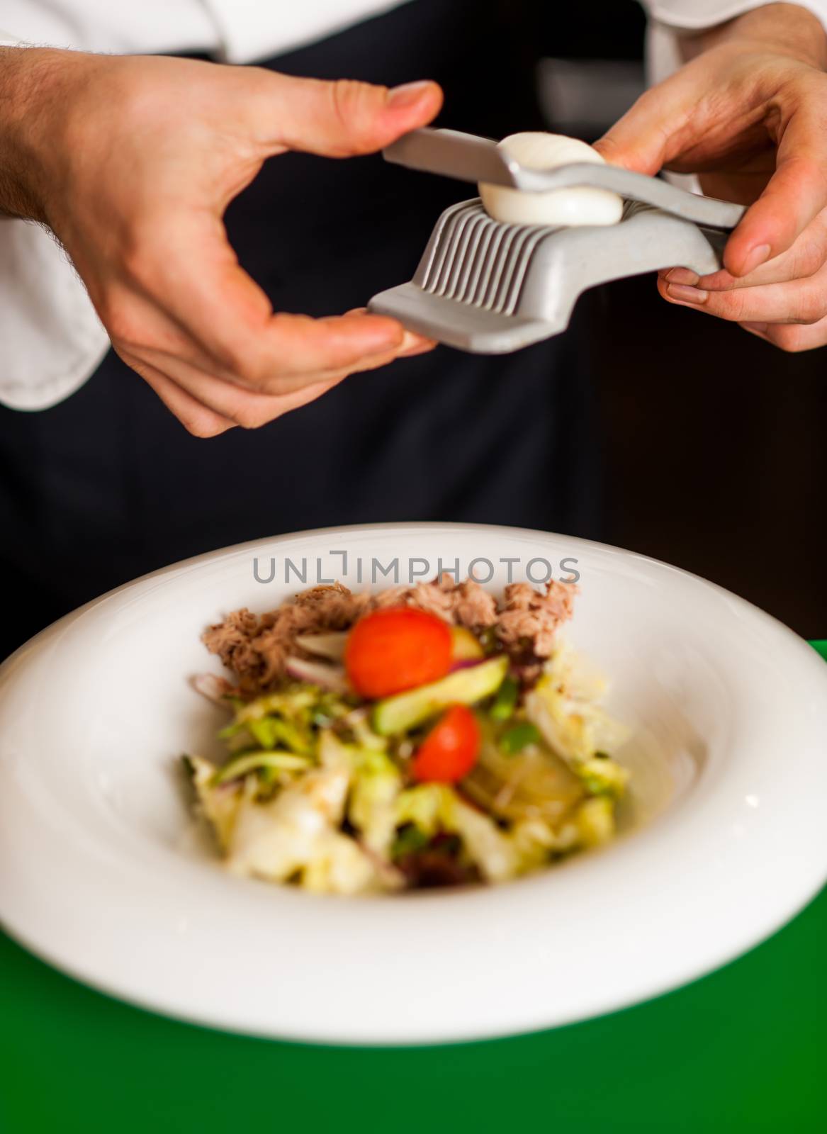 Tossed salad, almost ready to be served by stockyimages