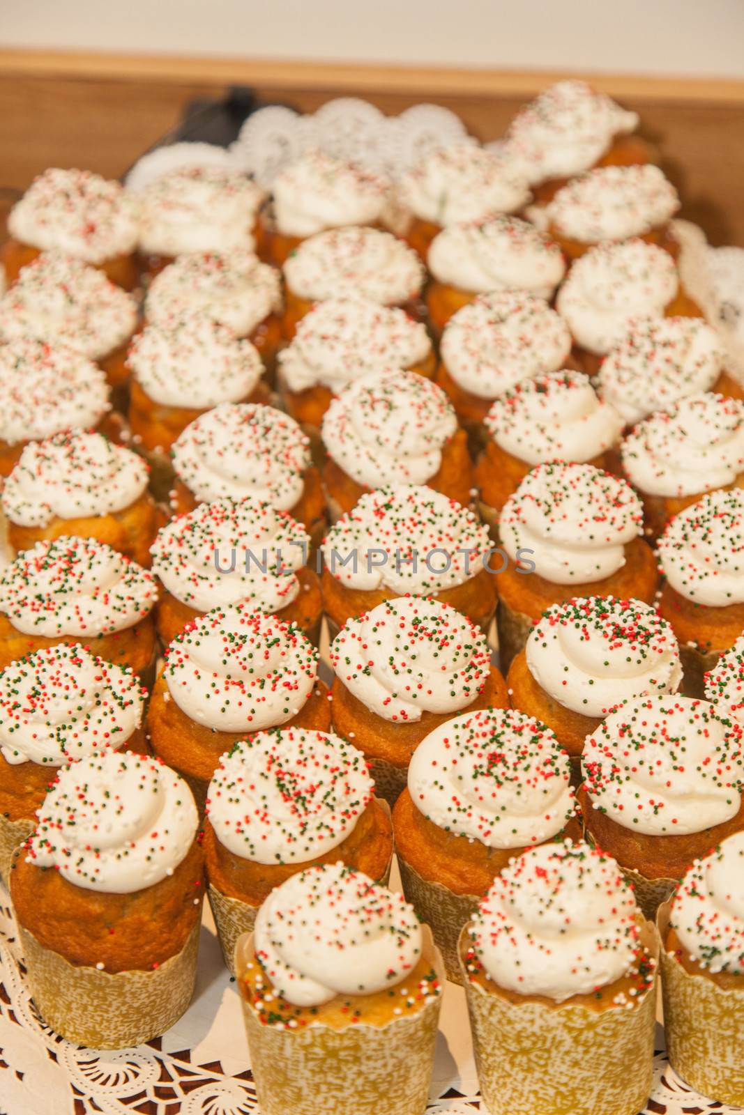 Large tray of delicious cupcakes during end of the year celebration party.
