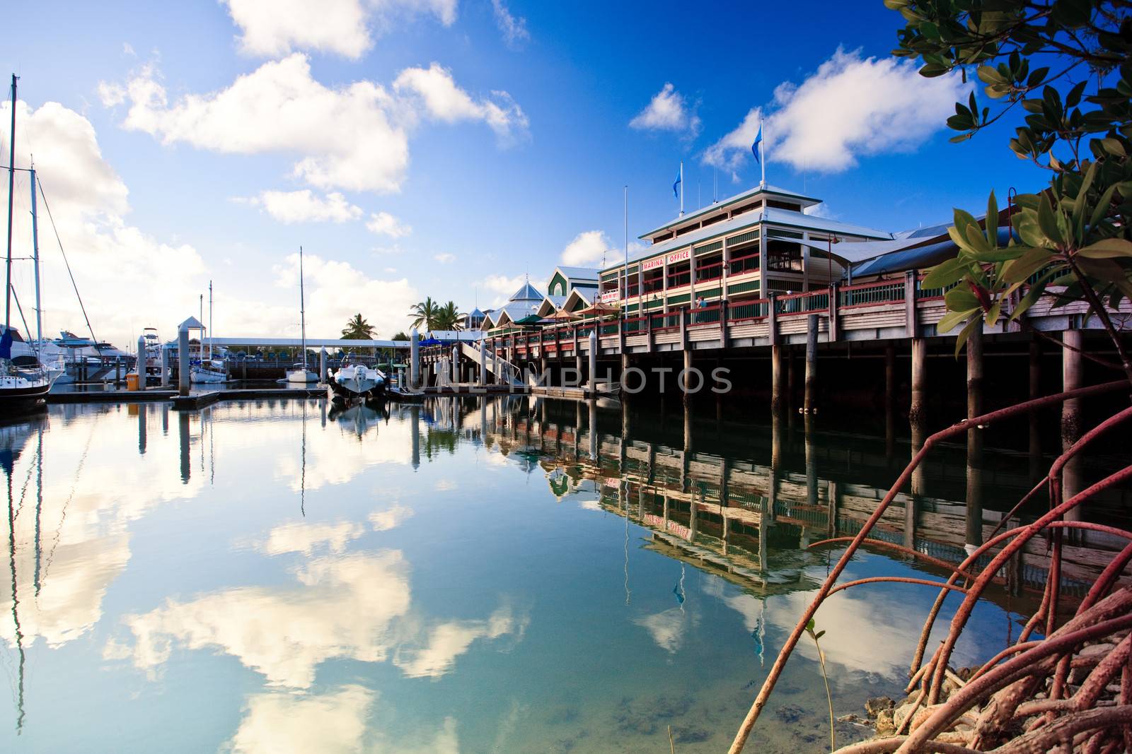 Reflection of the clouds in a calm marina by jrstock