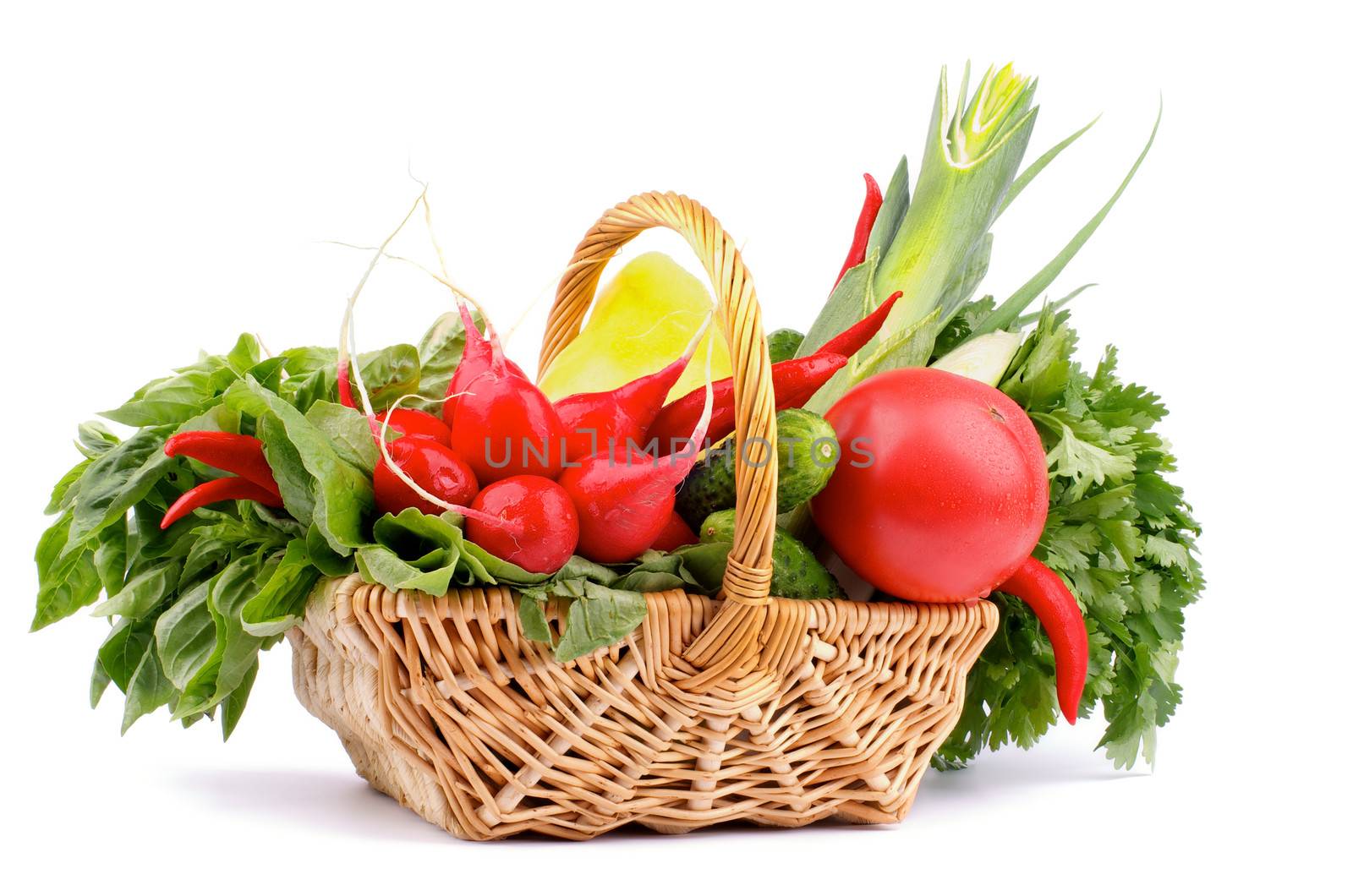 Vegetable Basket with Radish, Basil, Chili Pepper, Bell Pepper, Cucumbers, Leek, Parsley and Tomato isolated on white background