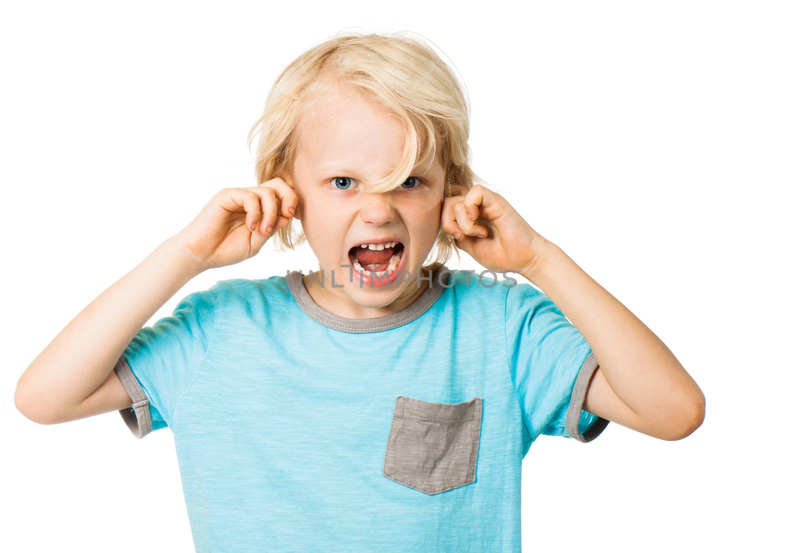A young angry boy screaming and blocking his ears. Isolated on white.