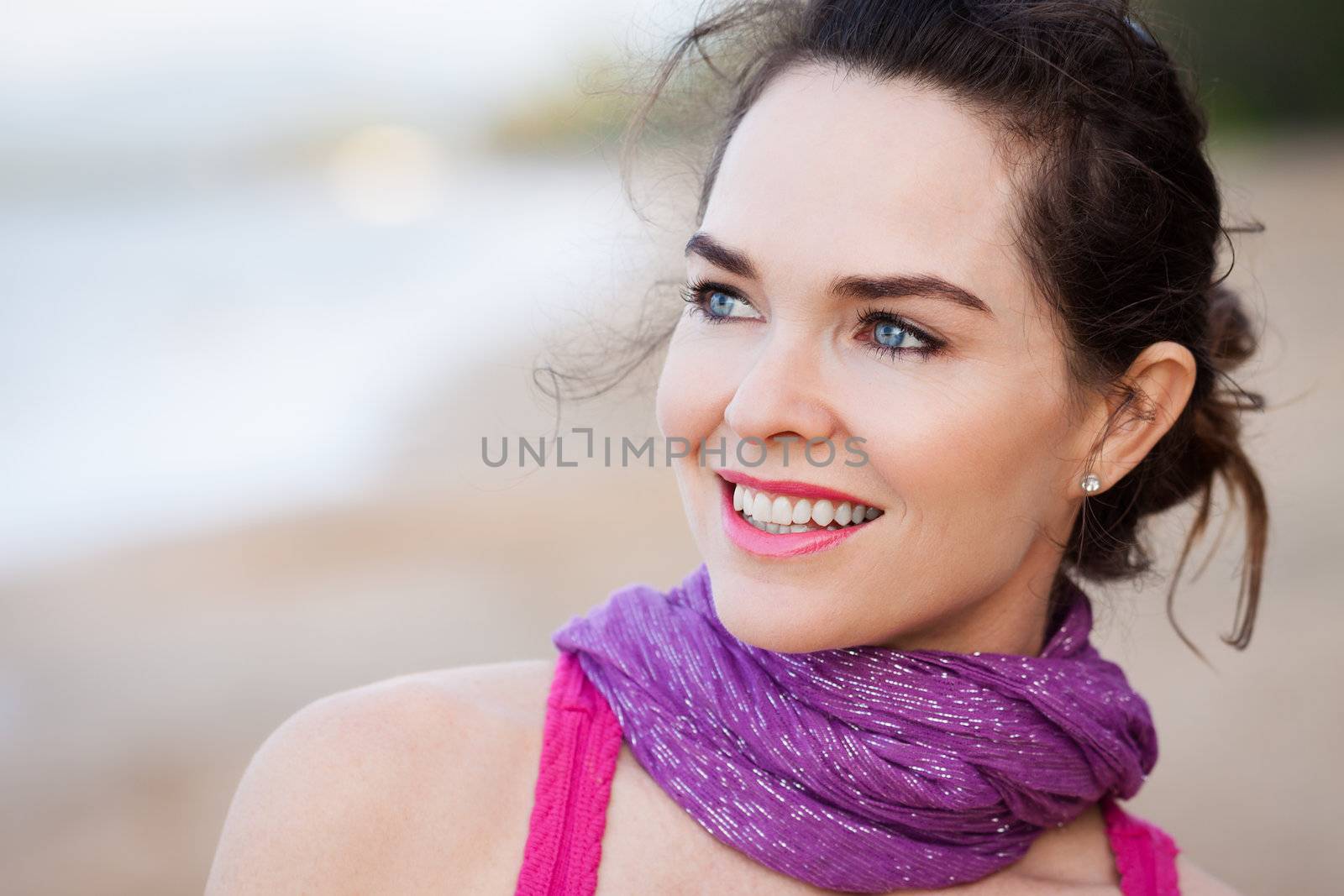 A close-up portrait of a beautiful happy  woman outdoors