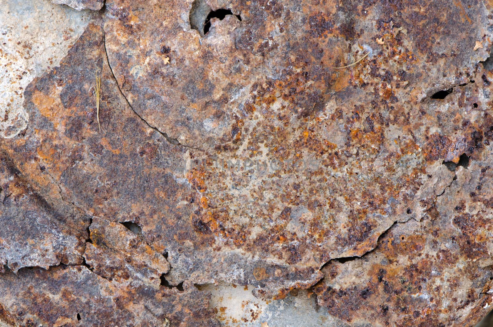 uneven cracked tin with rust stains background