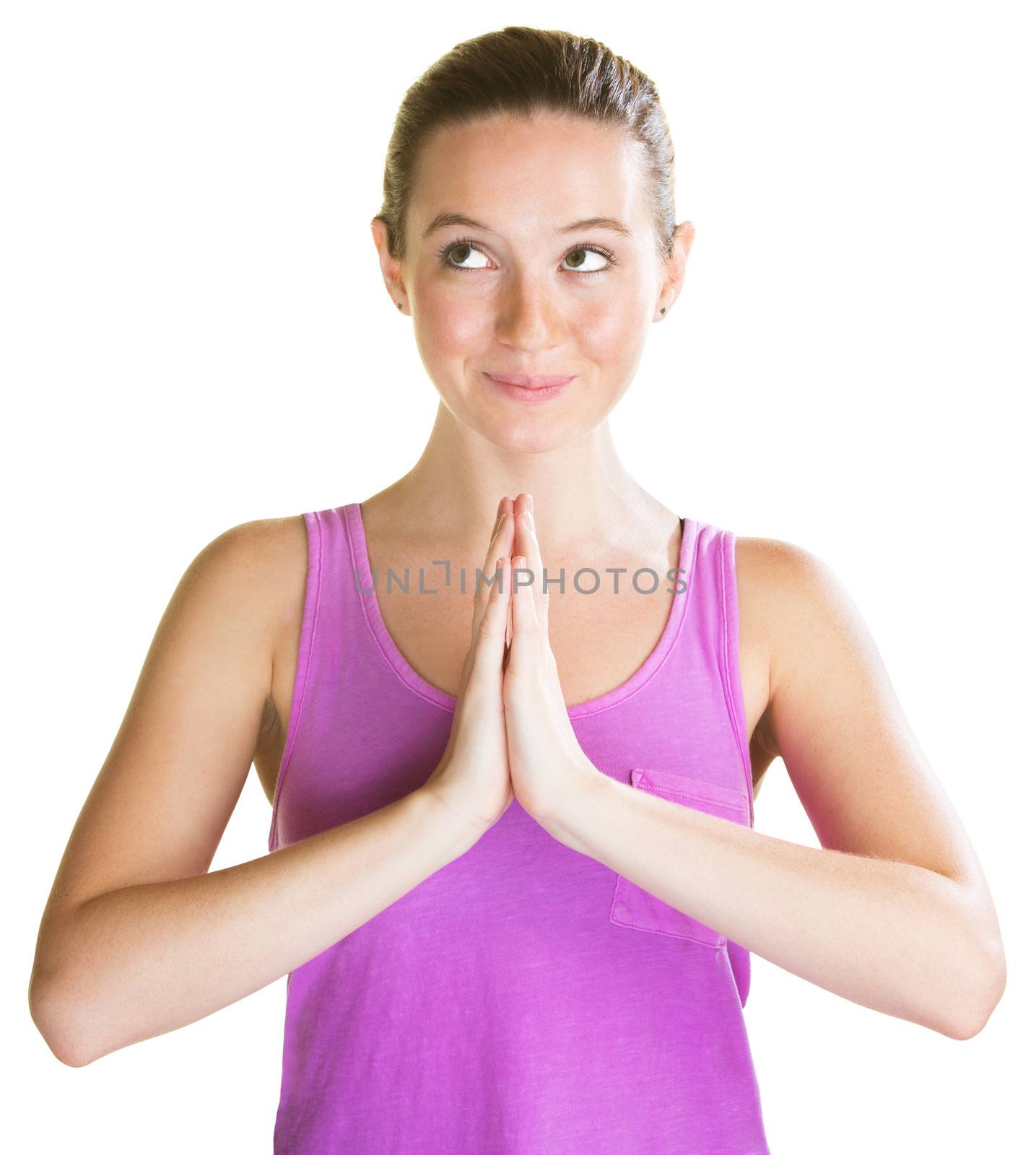 Cute young woman praying and looking over