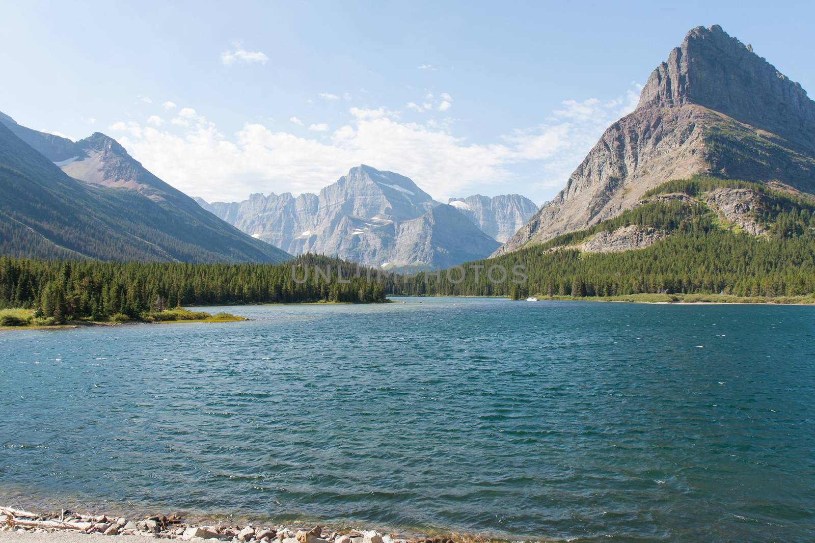 Swiftcurrent Lake is behind the Many Glaciers Hotel in Glacier National Park. The mountain in the center is Mt Gould which is a peak on the continental divide. 