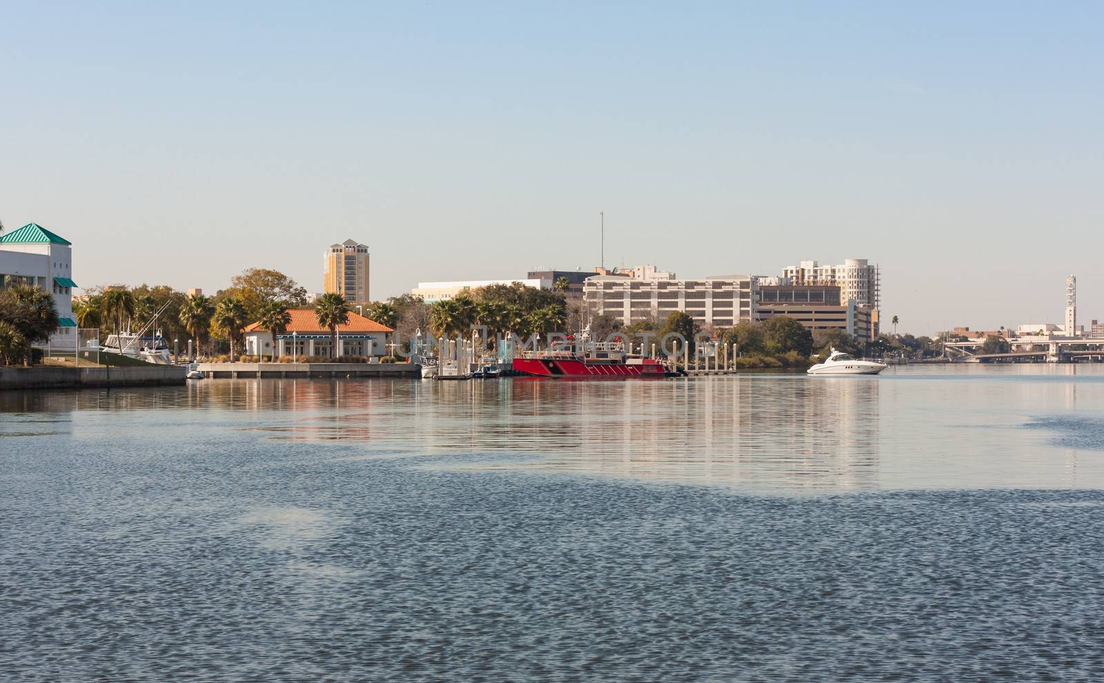 Not only homes but businesses and services line the Hillsborough River at Tampa, Florida. The red boat in the middle of this image is the fire department.