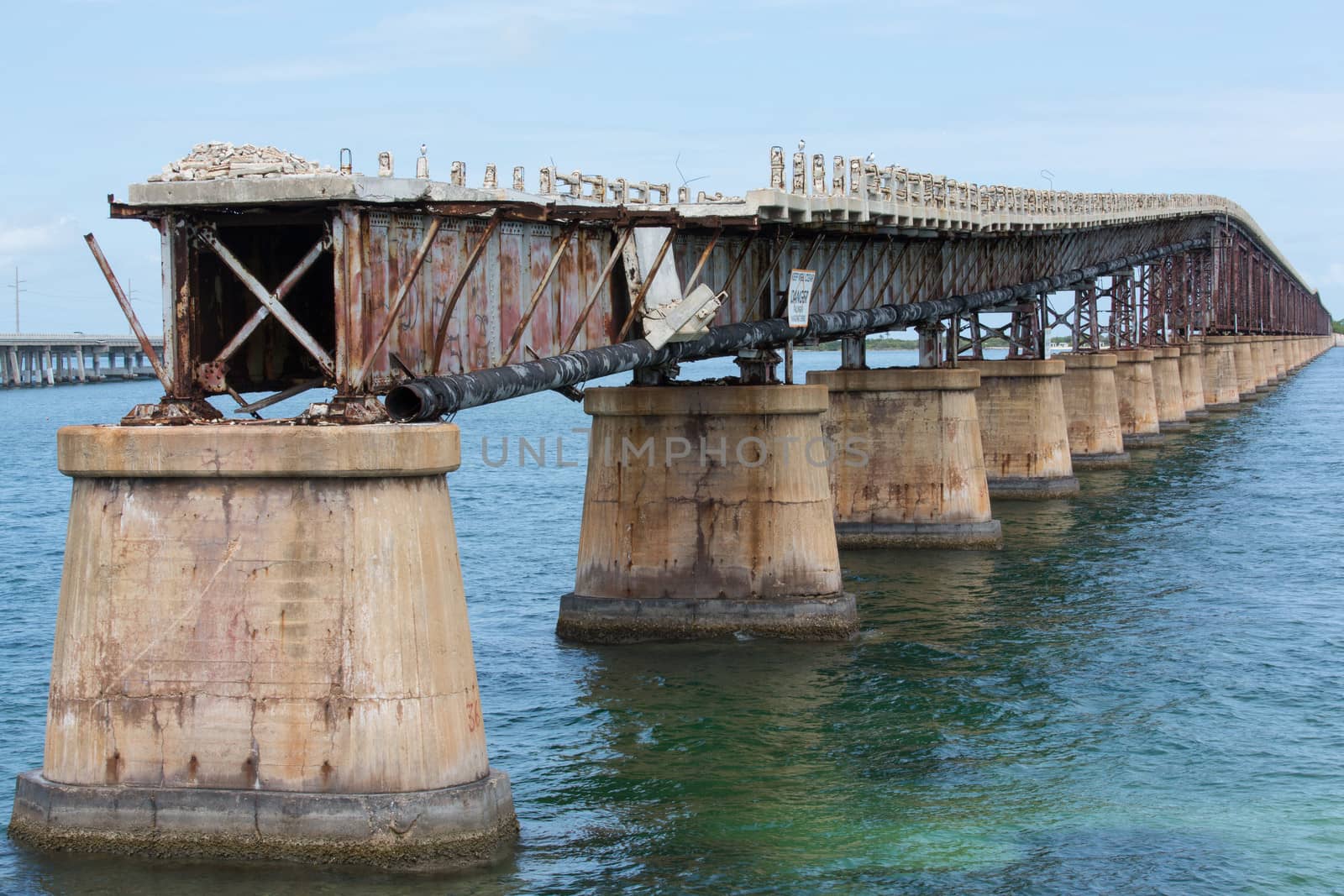 This bridge was built by Henry Flagler as part of the Overseas Railroad to Key West. Later it was converted to a highway by building the road on top of the trusses. It has since been replaced by a modern bridge and is left to slowly deteriorate into the ocean.