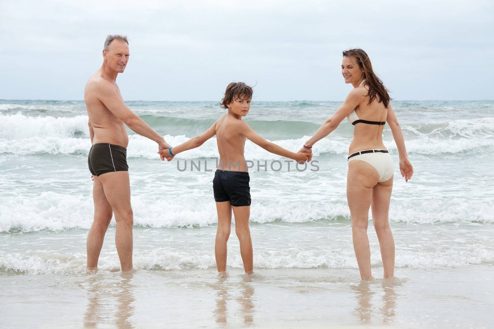 happy family ith two boys having fun in water summer holiday vacation