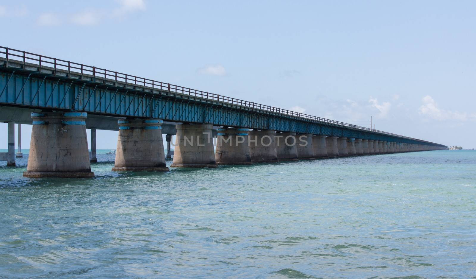 The Seven Mile bridge was built by Henry Flagler as part of the Overseas Railroad to Key West. After a hurricane shut down the railroad, Florida purchased this bridge and used it as part of the overseas highway to Key West. Today this 2.2 mile section is used for pedestrians, fishermen, and bicyclists and connects to Pigeon Key. The new seven mile bridge can be seen running alongside the old bridge.