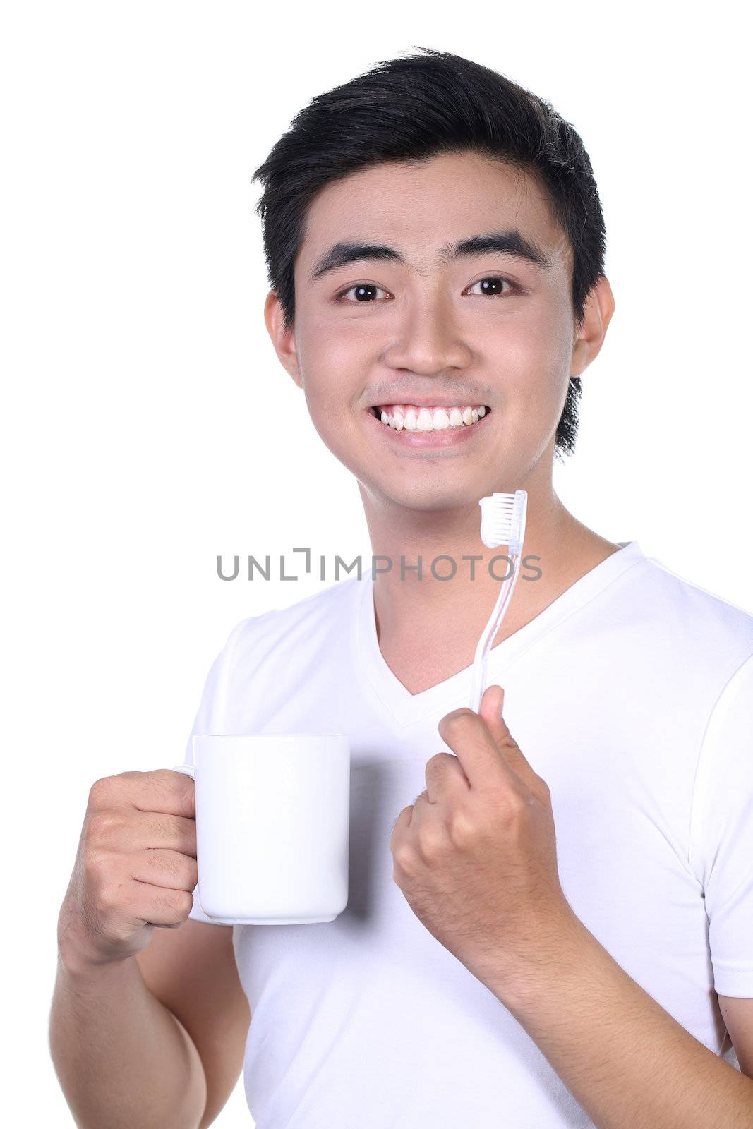 Asian guy brushing teeth, isolated on white by frexifaces