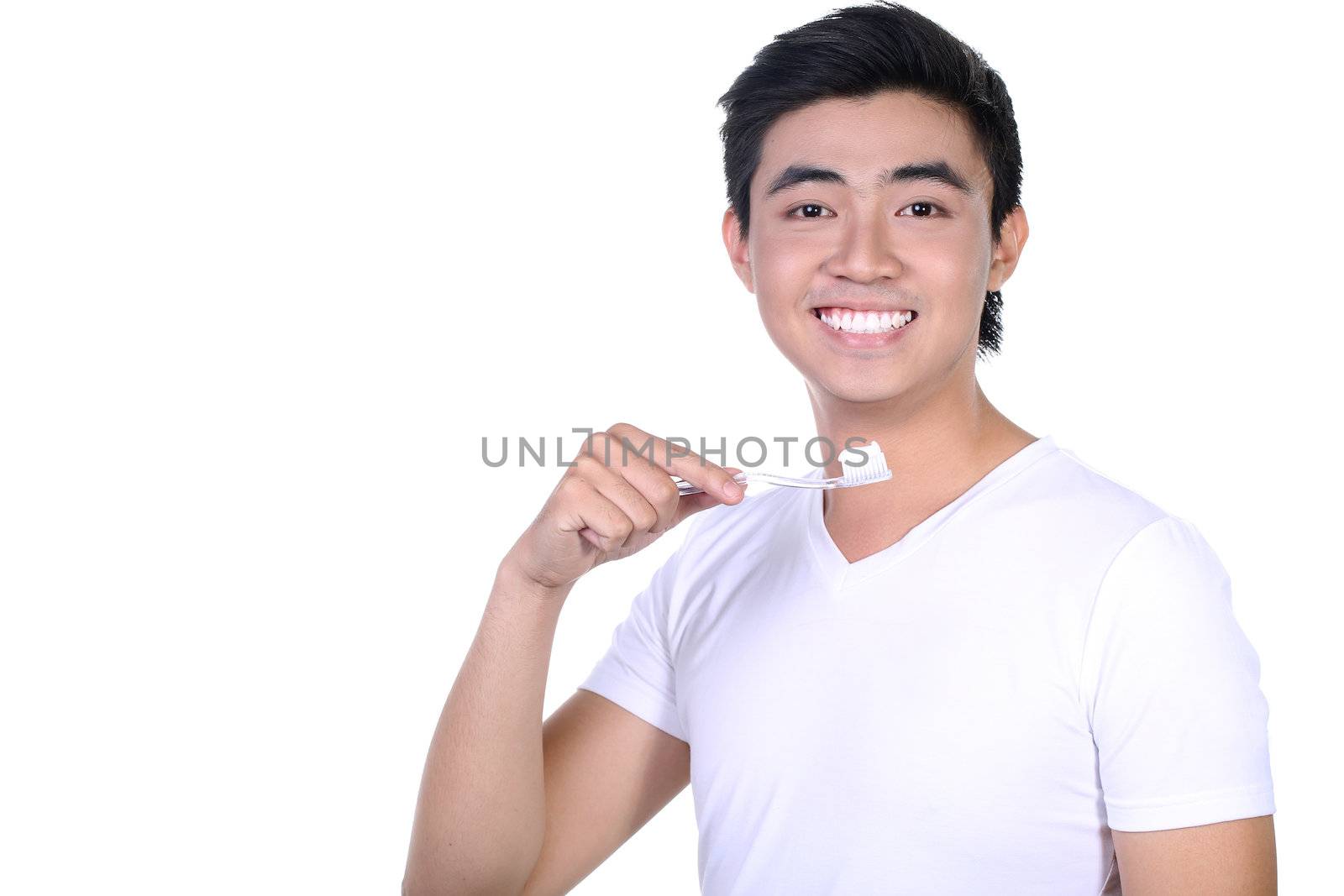 Asian guy brushing teeth, isolated on white