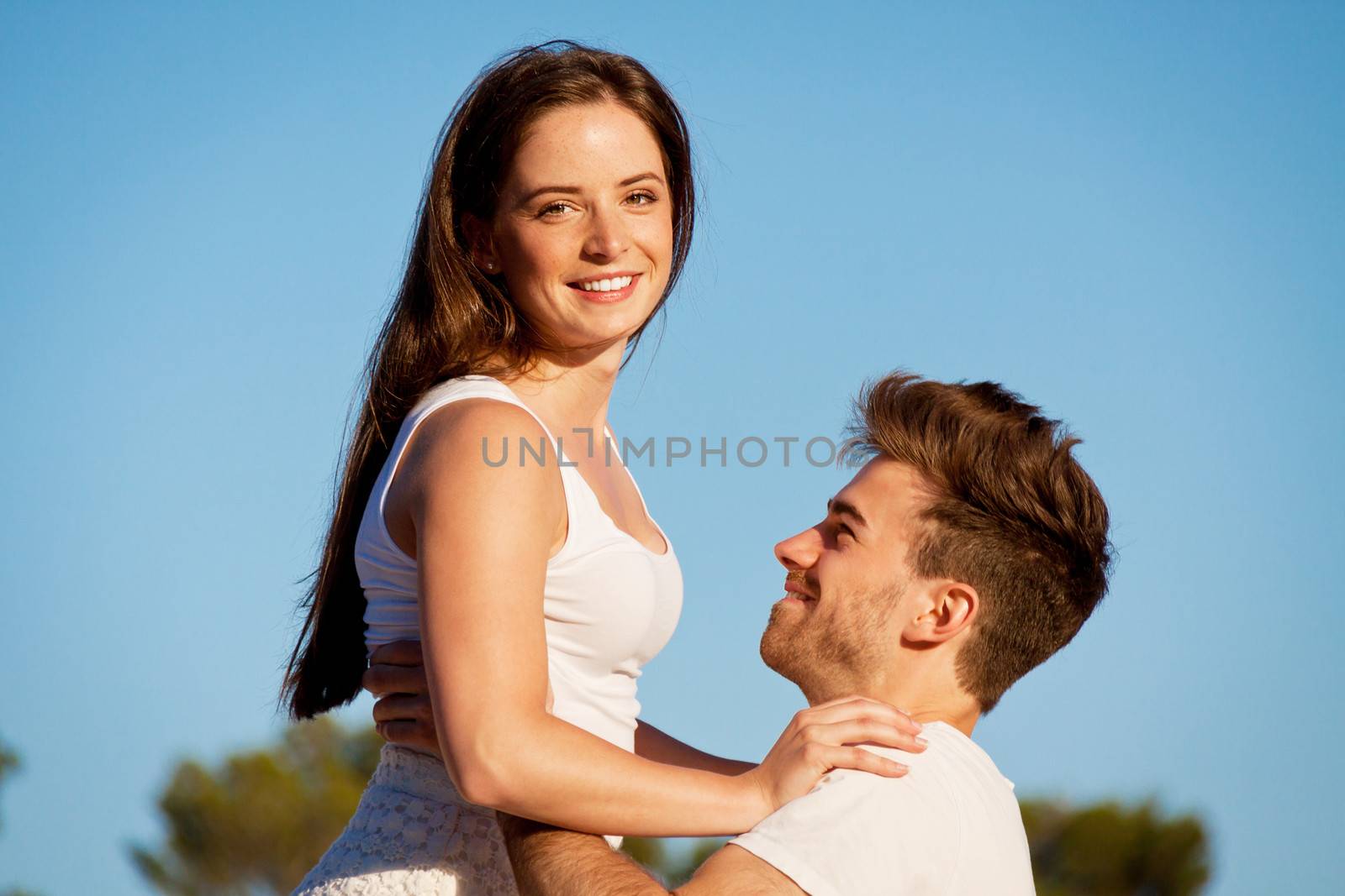 attractive young couple in love summertime on beach smiling romance