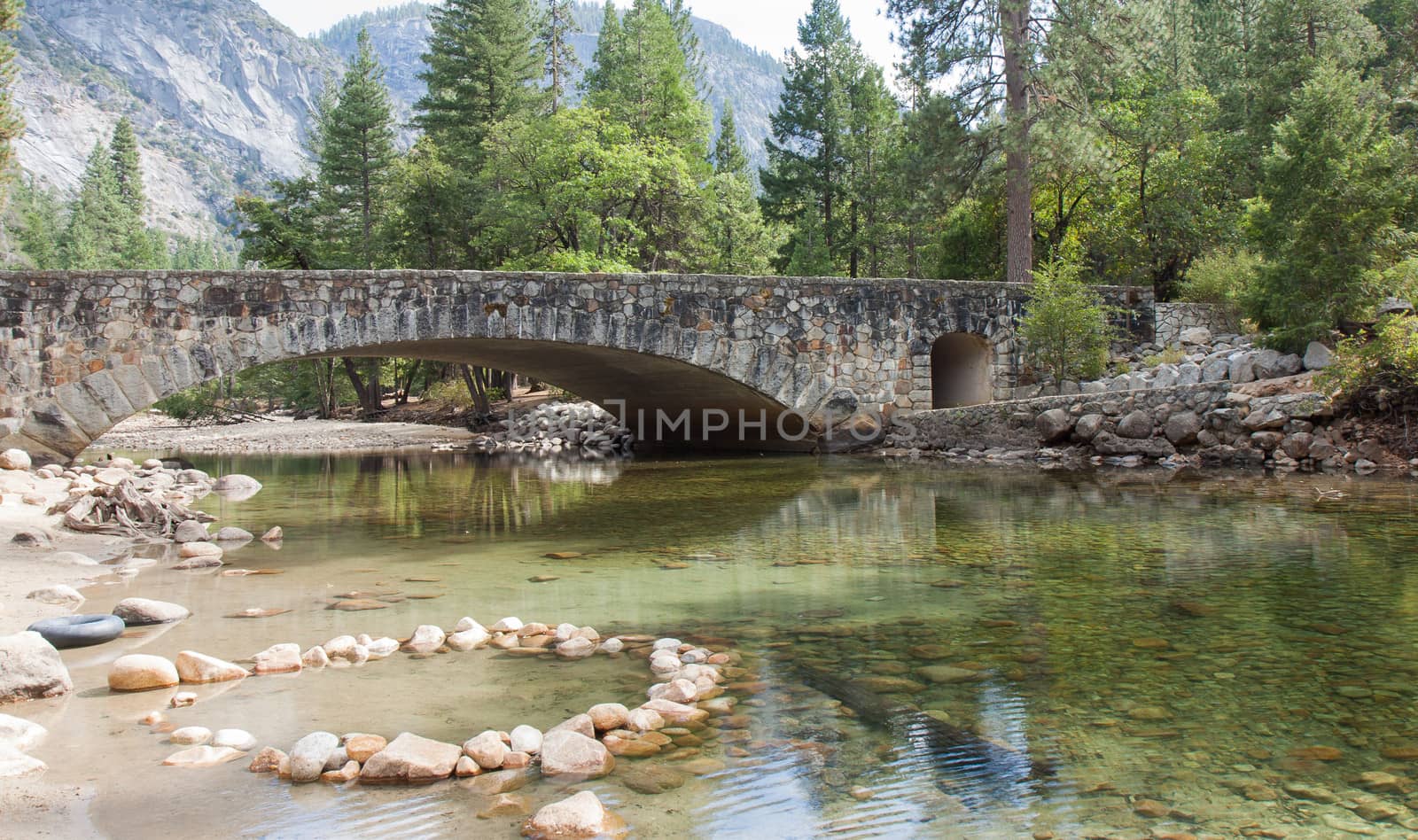 Crystal clear spring and a beautiful stone bridge in Yosemite Valley.