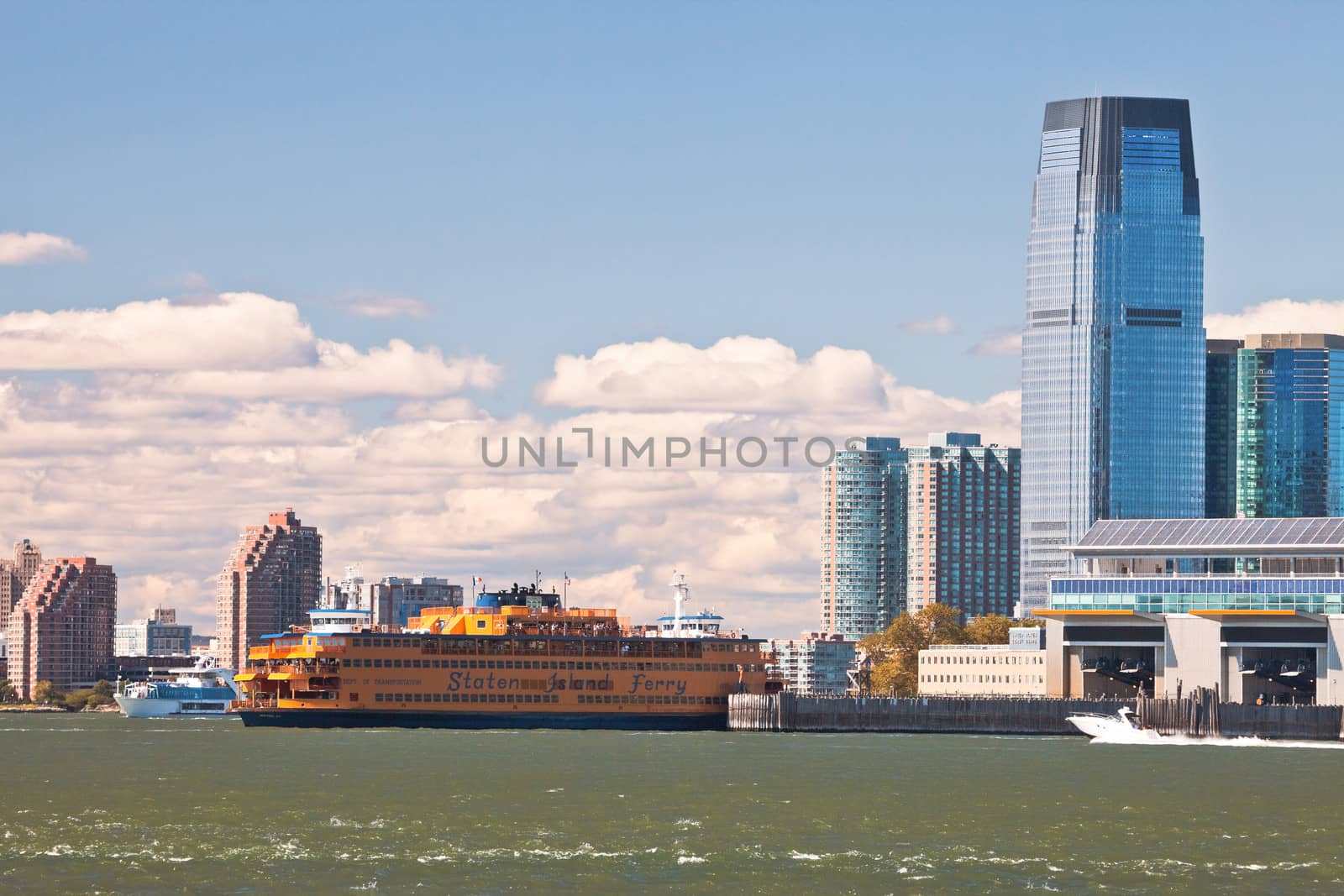 NEW YORK - SEPTEMBER 23: The massive Staten Island Ferry departs from Battery Park in New York City on September 23, 2012. It is a free rides that offers great views of the skyline, and also carries cars.