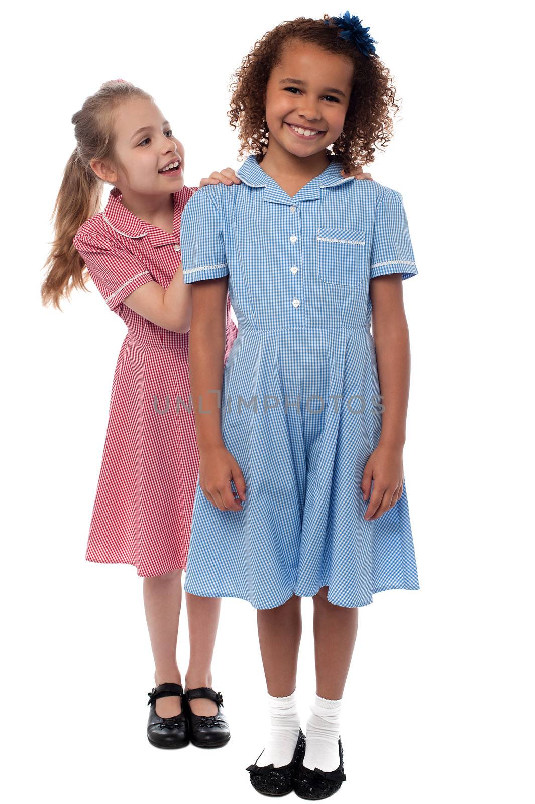 Two joyous elementary school girls by stockyimages