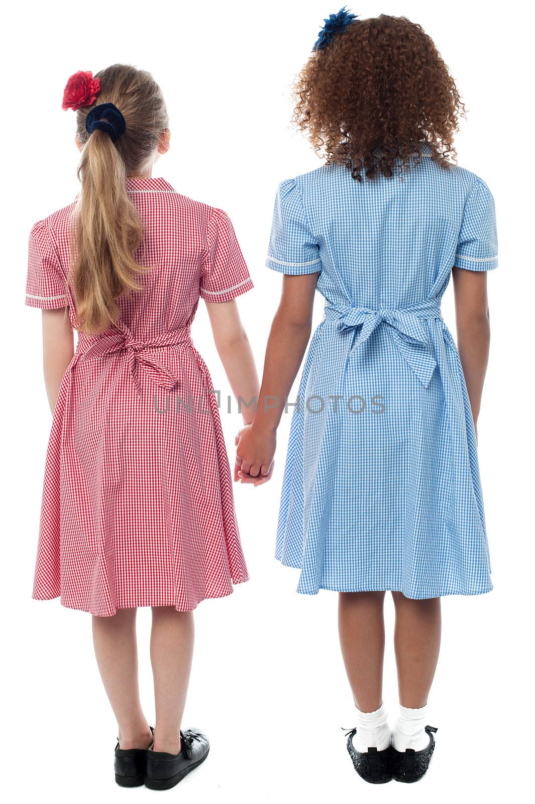 Girls in school uniform facing the wall by stockyimages