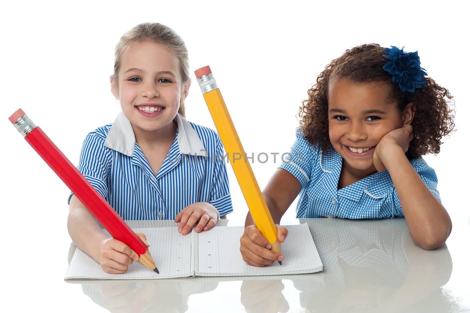 Kids completing their assignment by stockyimages