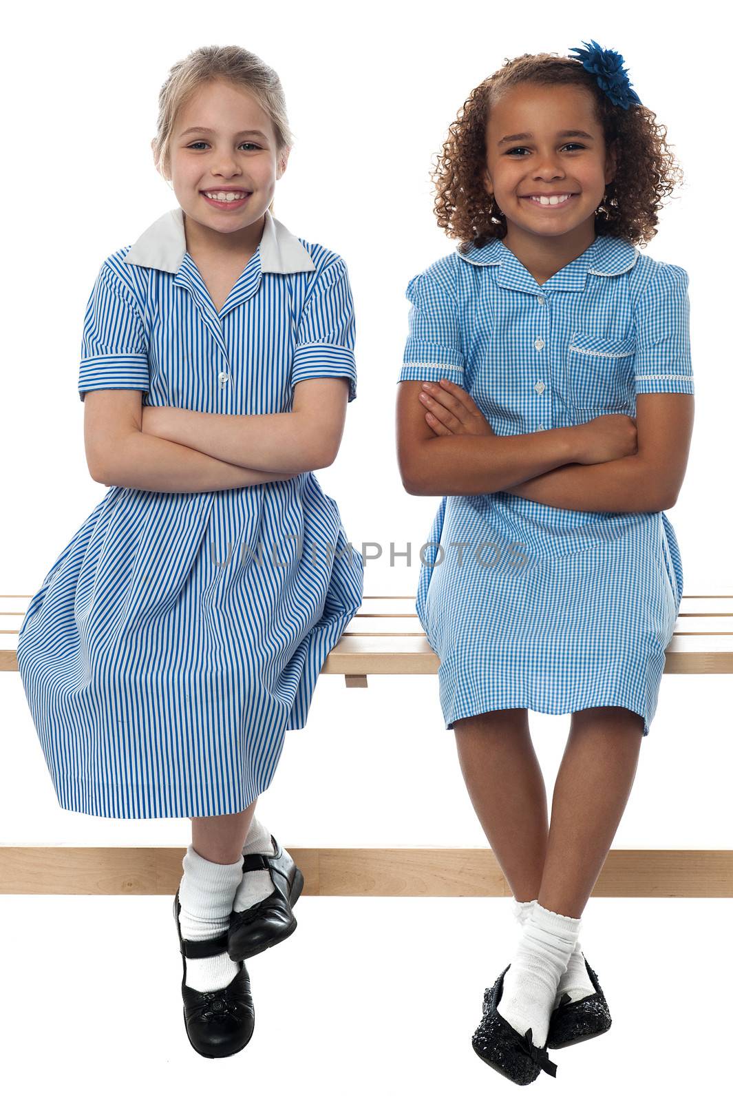 Cheerful school girls posing confidently