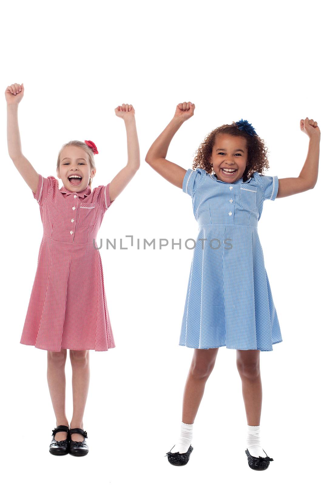 Two excited young girls in joyous mood by stockyimages
