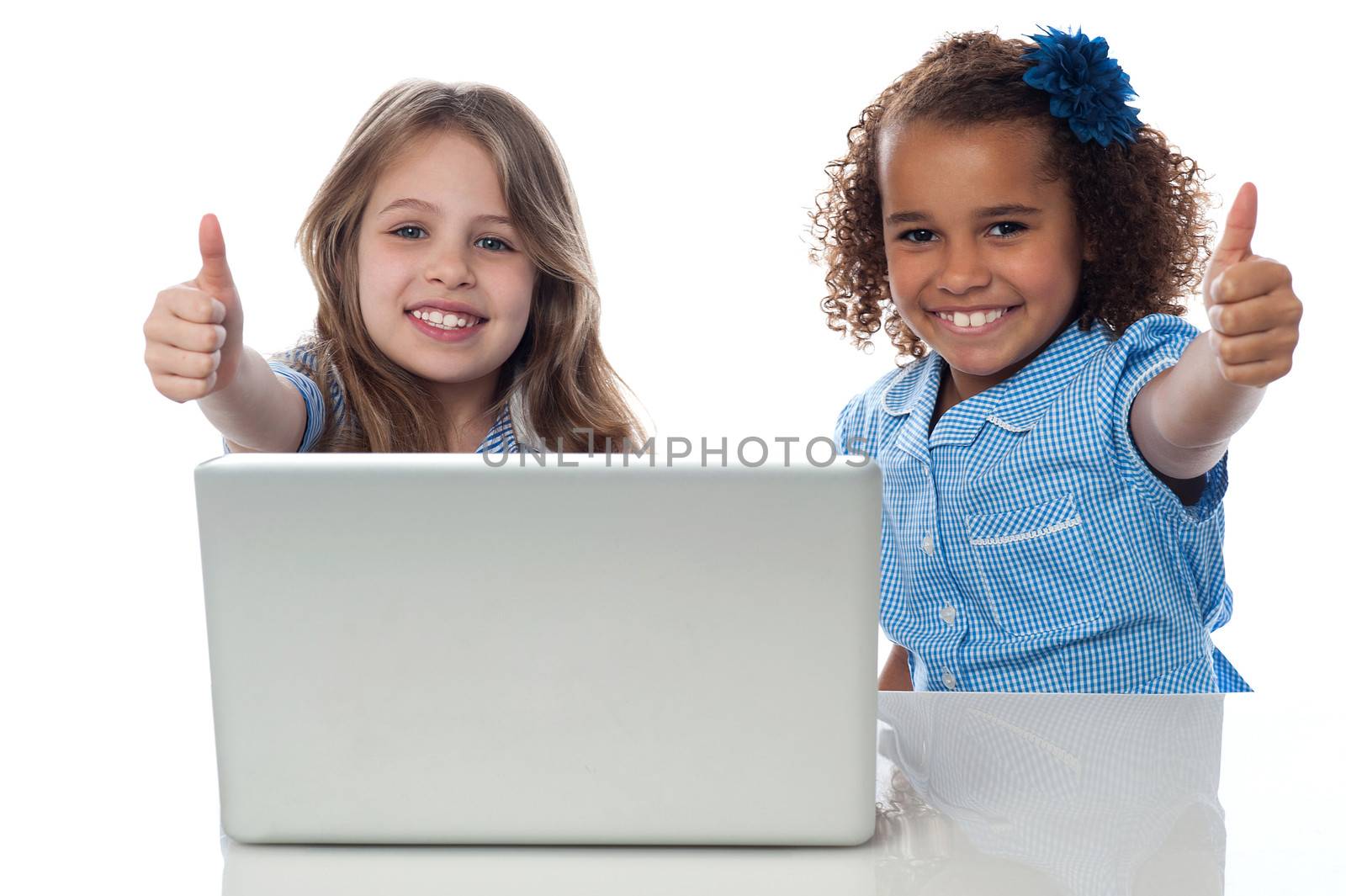 School kids with laptop gesturing thumbs up