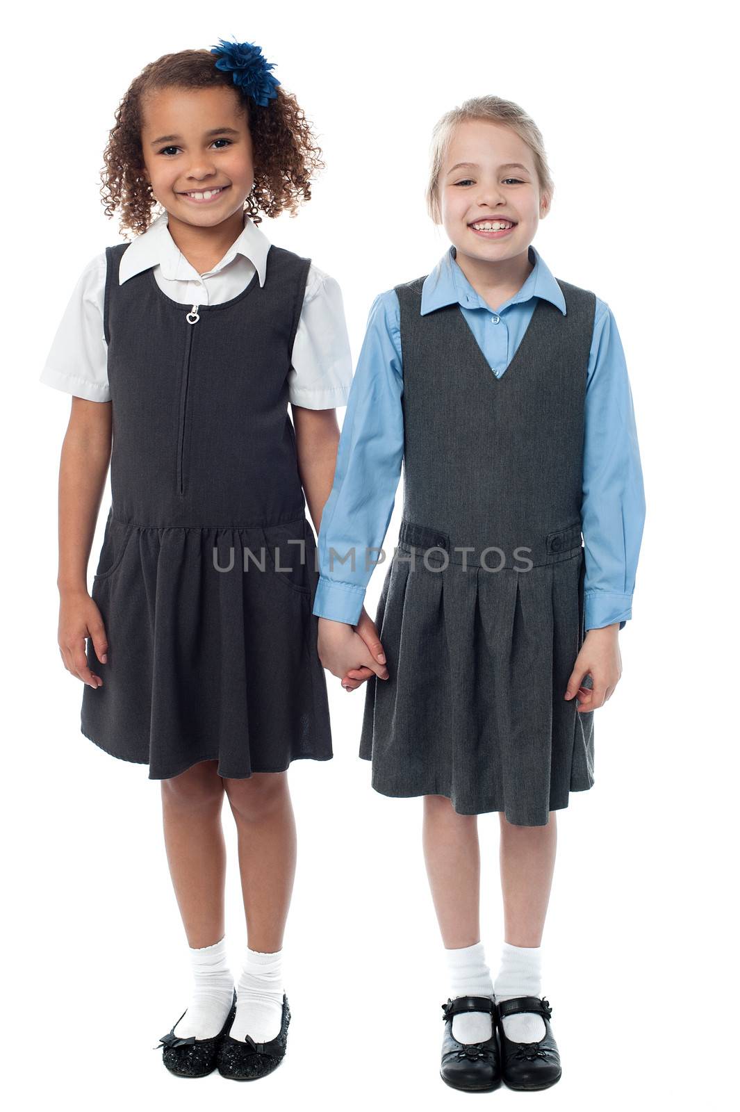 Smiling girls in school uniform by stockyimages