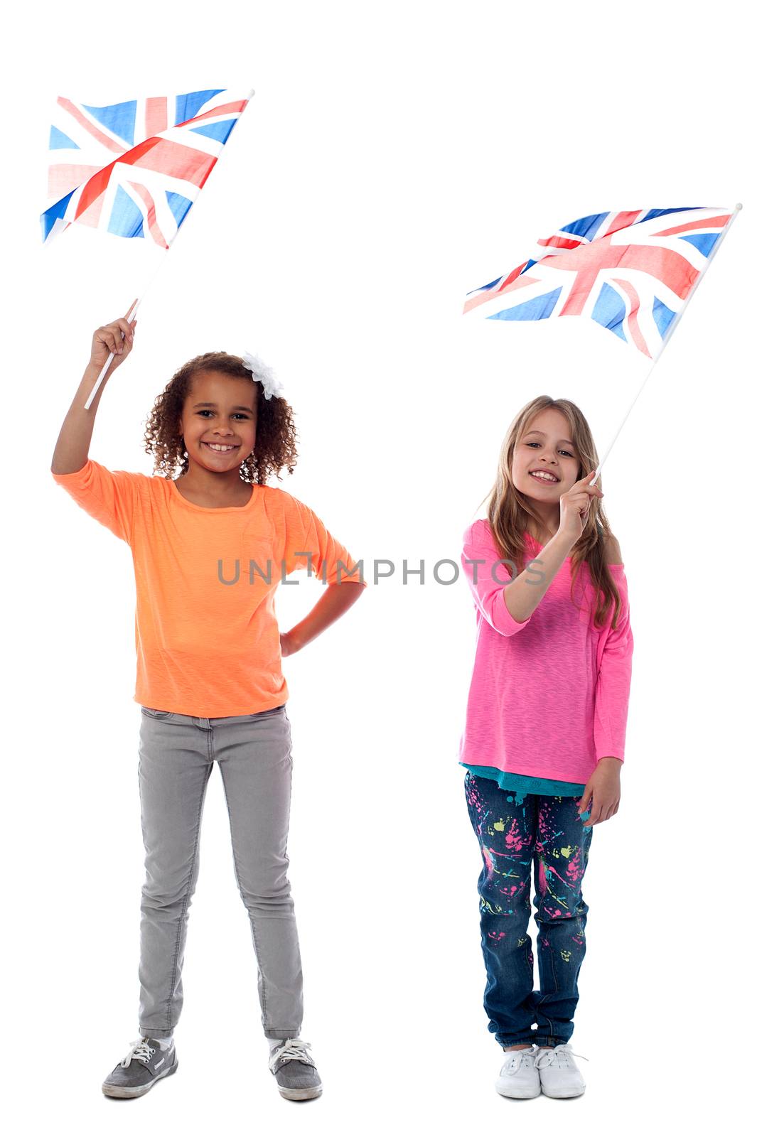 Girls waving United Kingdom flags by stockyimages