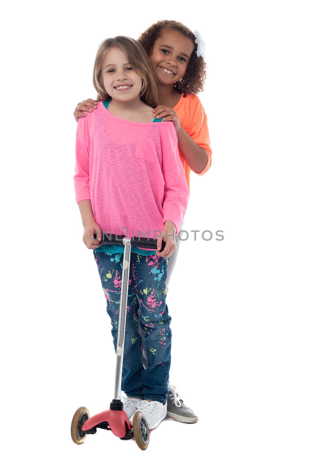 Little girls with skate scooter by stockyimages