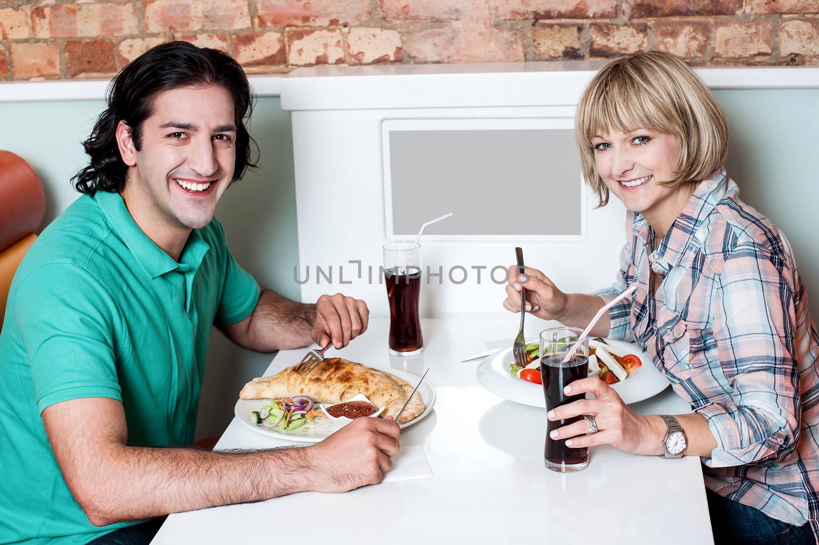 Loving young couple enjoying lunch together