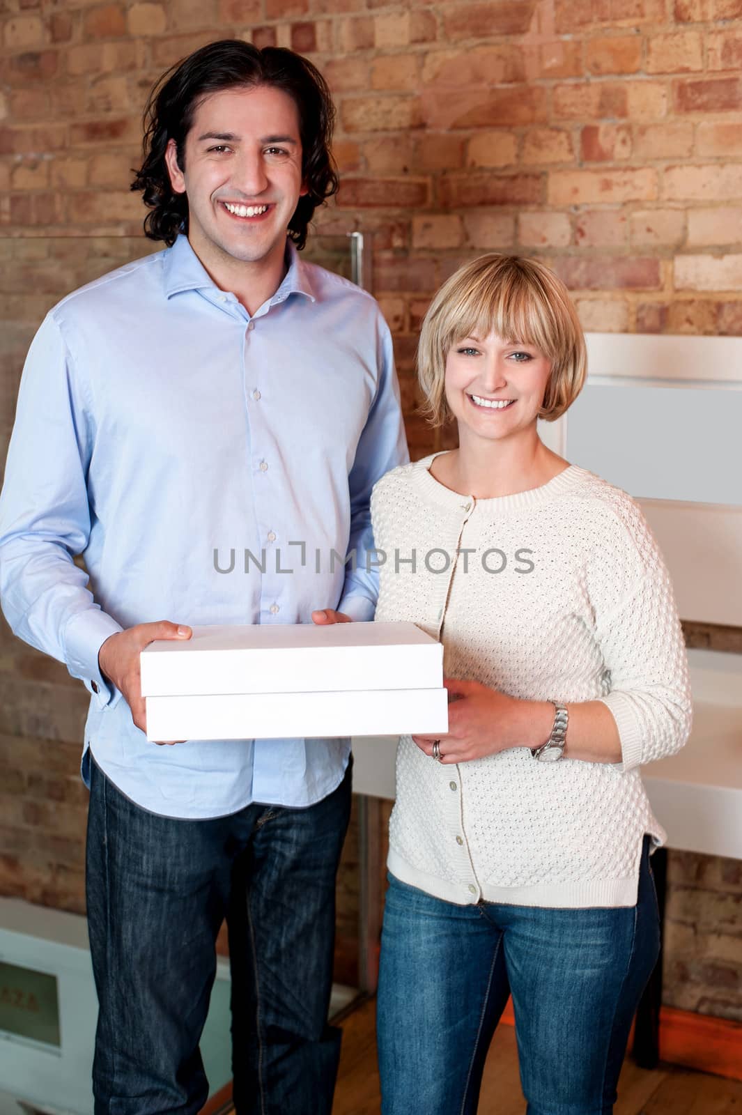Young couple holding packed pizza boxes