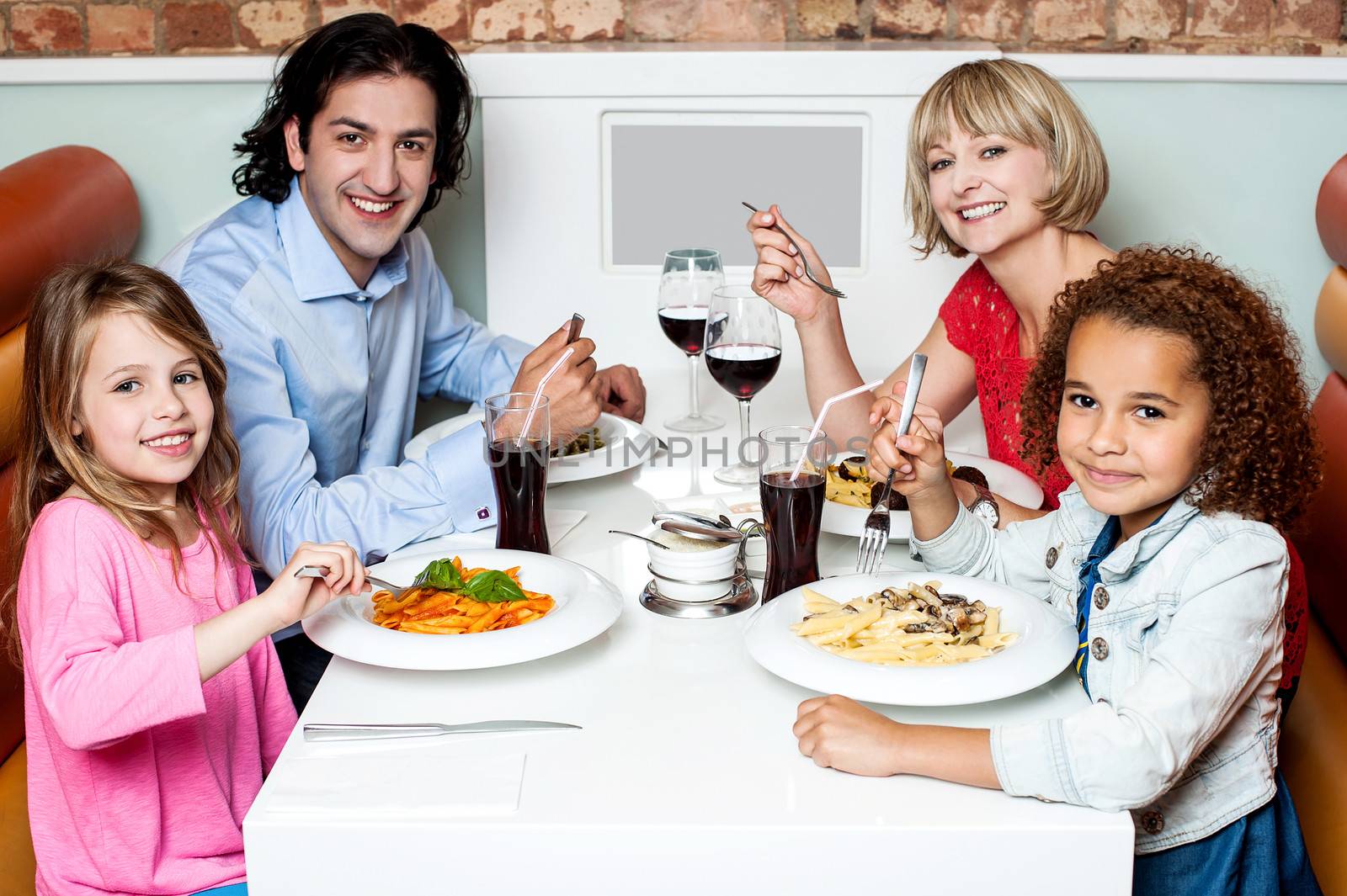 Family enjoying dinner outdoors on weekend