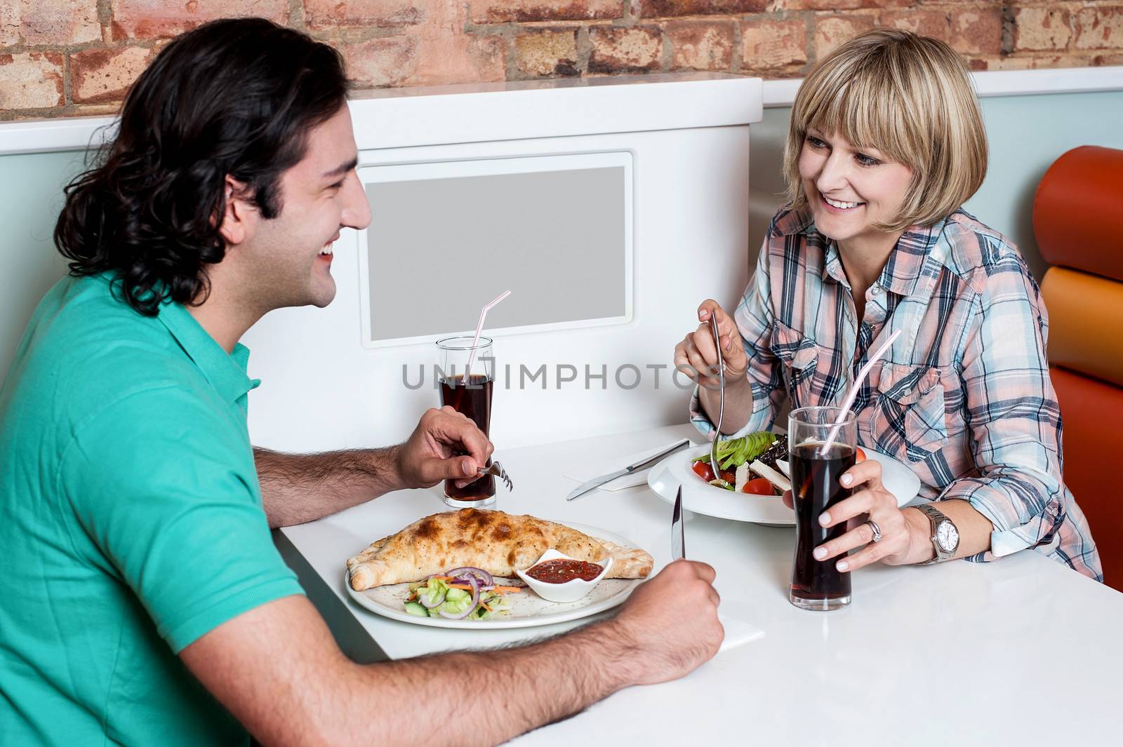 Couple enjoying dinner at a restaurant by stockyimages