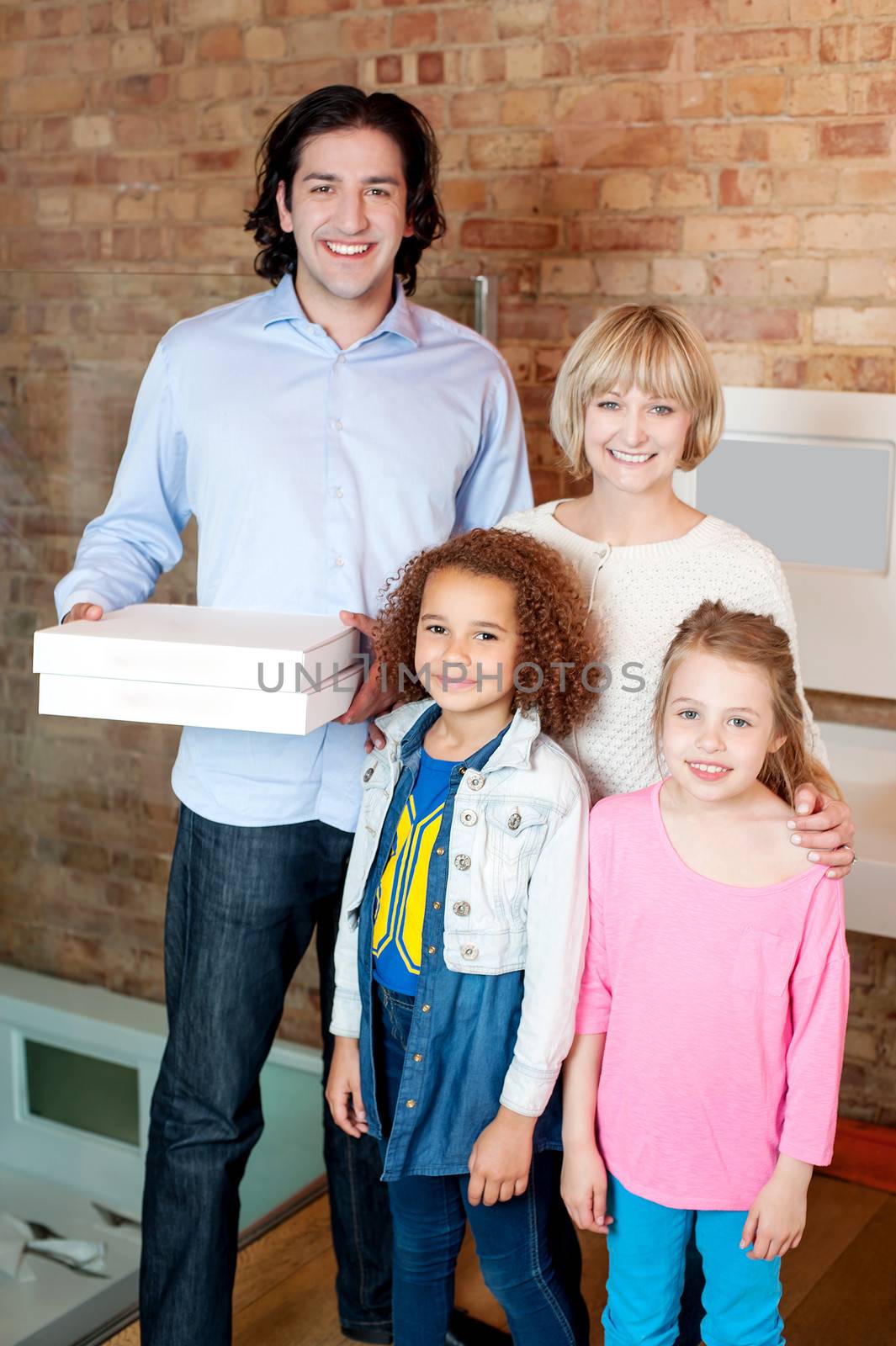 Young man with his family holding pizza boxes
