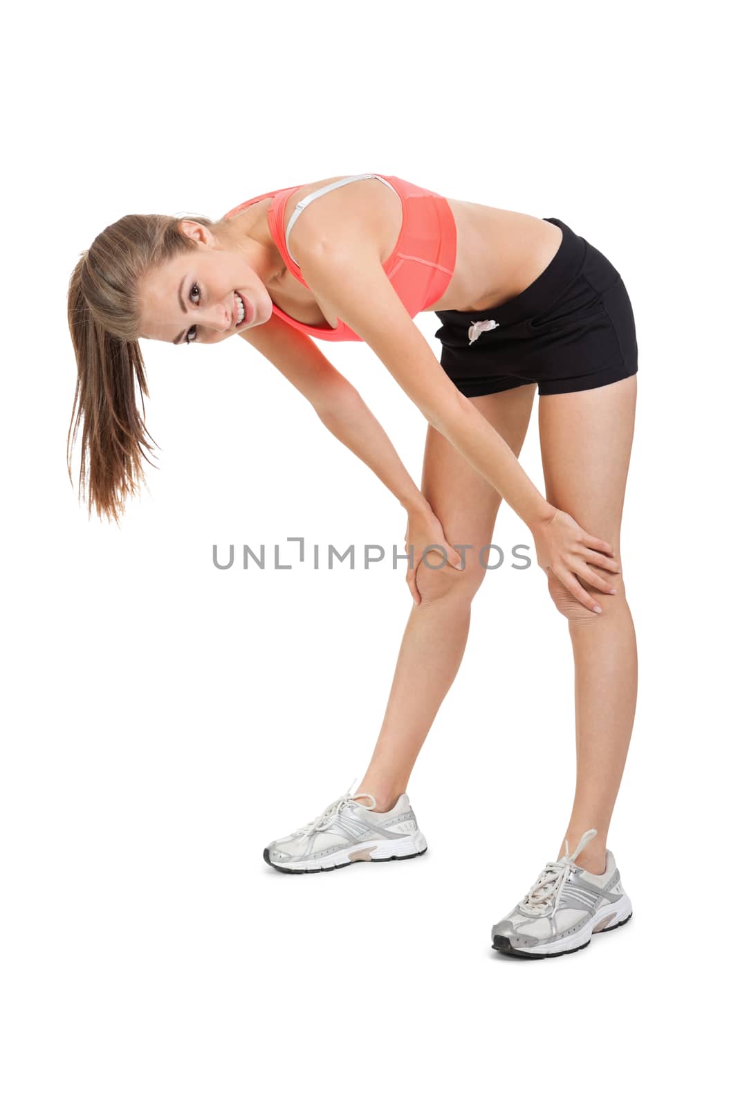 young attractive woman stretching legs after jogging isolated on white