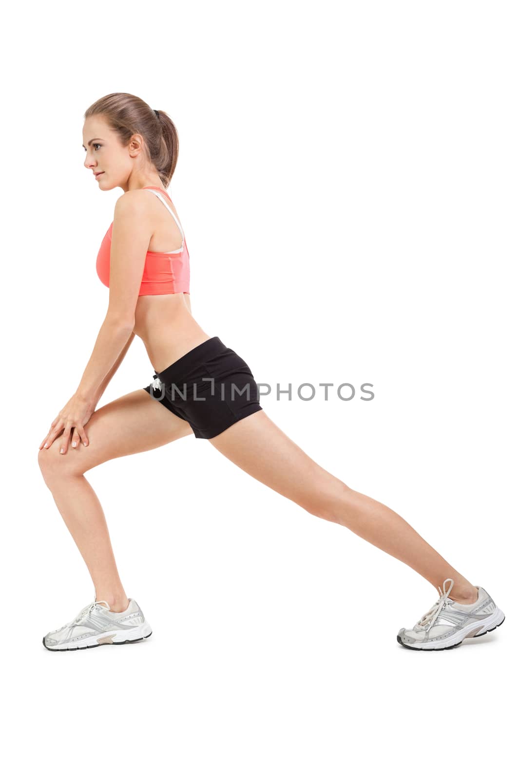 young attractive woman stretching legs after jogging isolated by juniart