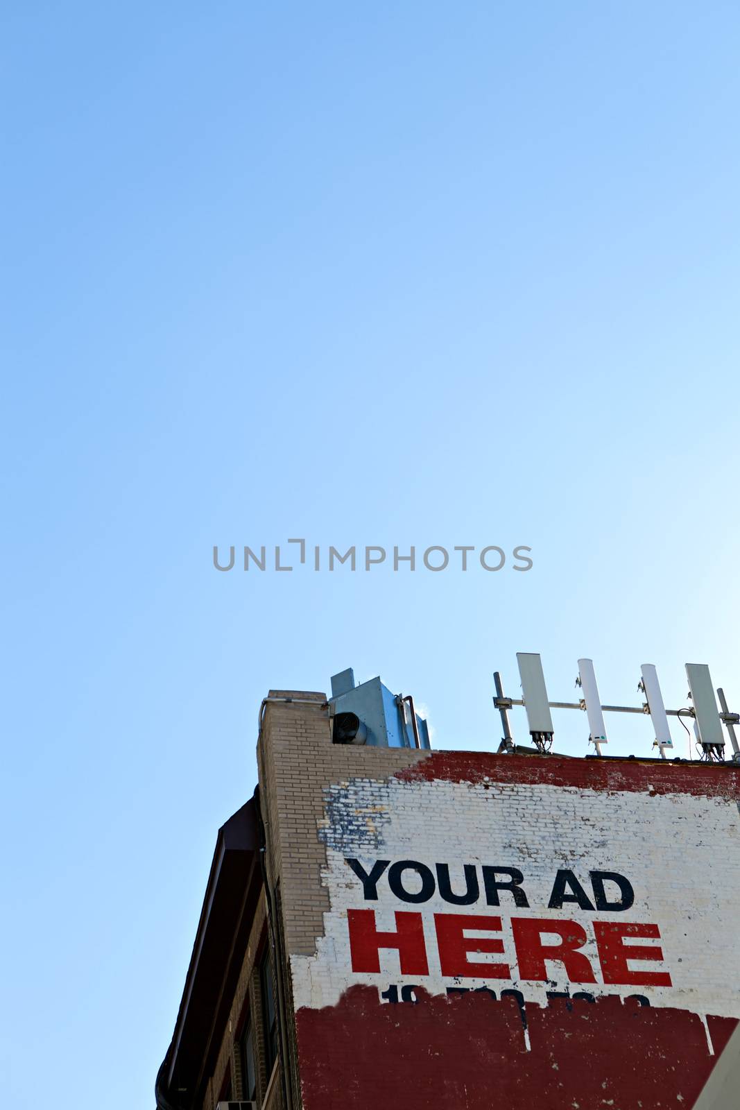 Your ad here sign as seen on the side of an old city building. Plent of copy space for your text or mockup ad design.