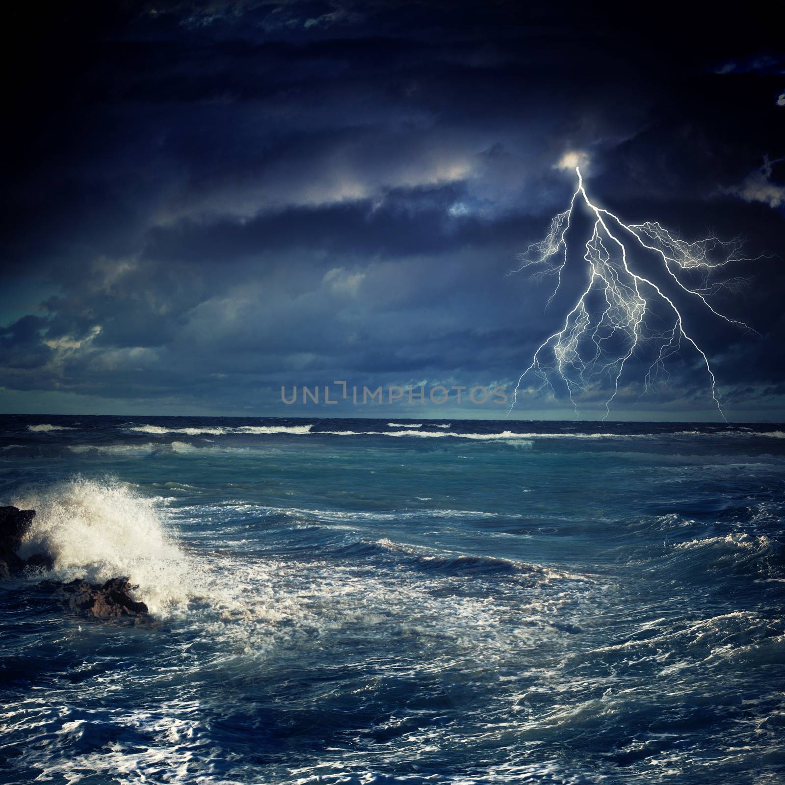 Image of night stormy sea with big waves and lightning