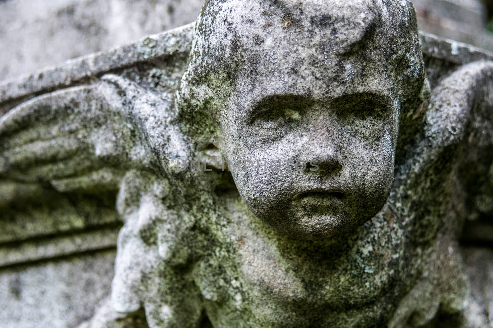 detail of a mourning sculpture on a cemetery