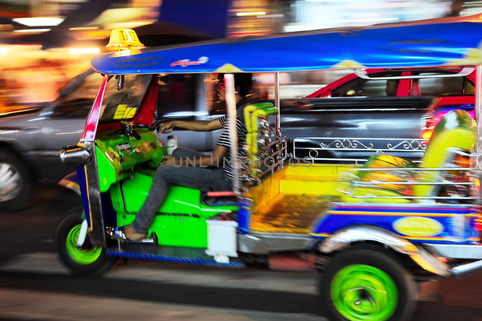 Bangkok, Thailand - March 03, 2013: Tuk - tuk on Chinatown street at night  in Bangkok. There are more than 100,000 "tuk-tuk" in Bangkok