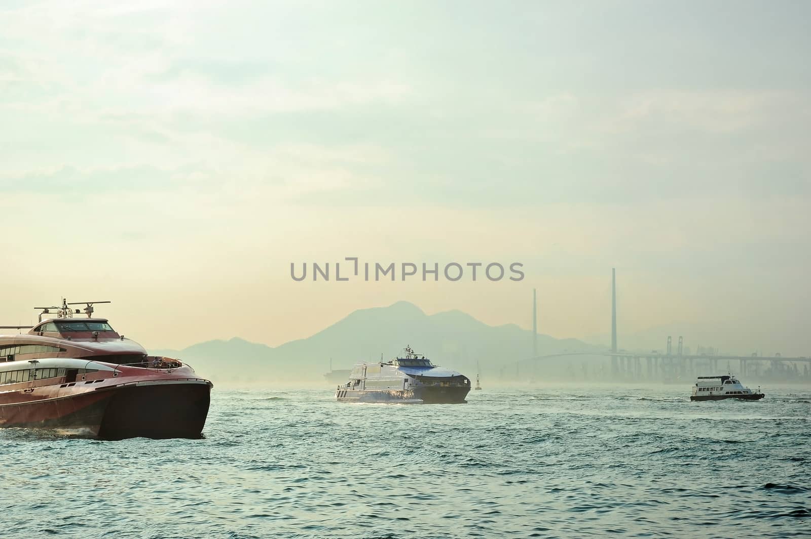 Macao to Hong Kong ferry boats in Hong Kong harbor. Tsing-Ma Bridge on the background