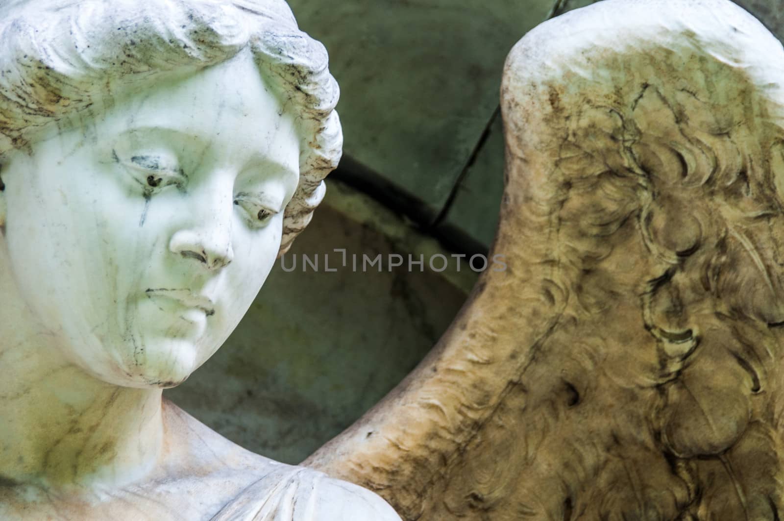 detail of a mourning sculpture on a cemetery