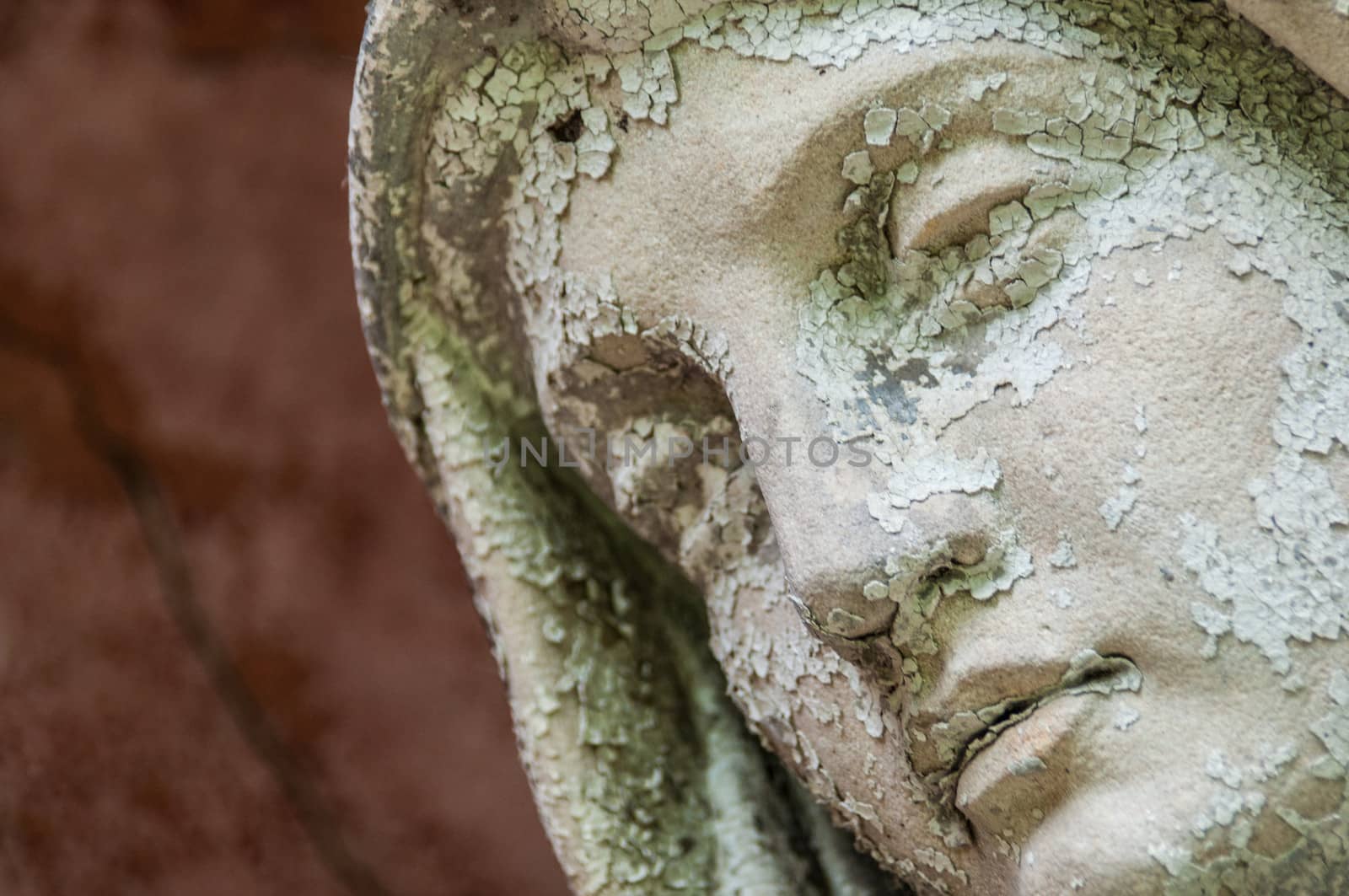 detail of a mourning sculpture on a cemetery