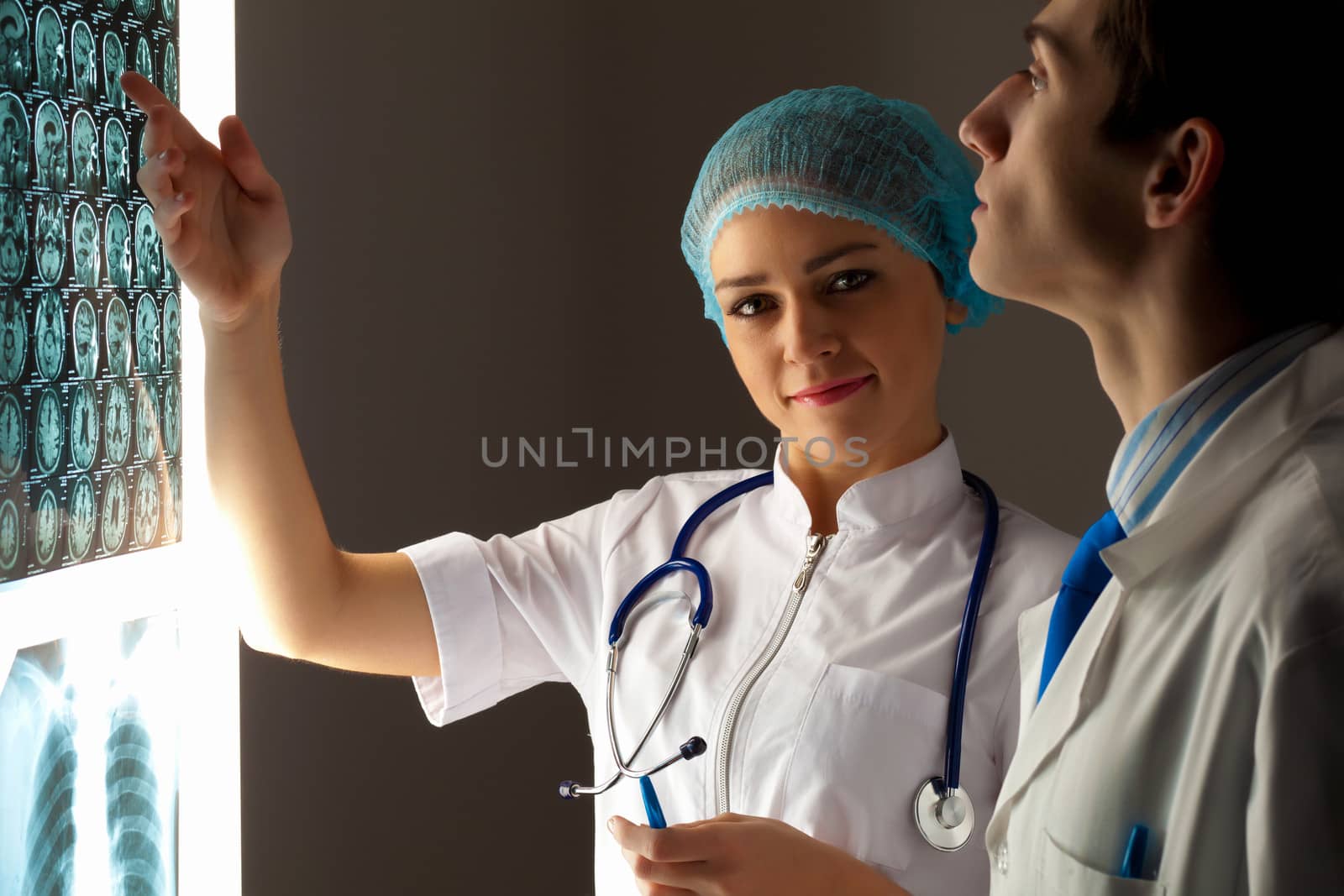 Two doctors examining x-ray results by sergey_nivens