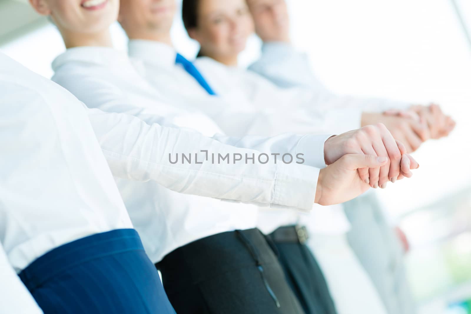 hands of businessmen, businessmen hold hands, stand in a row, the concept of teamwork