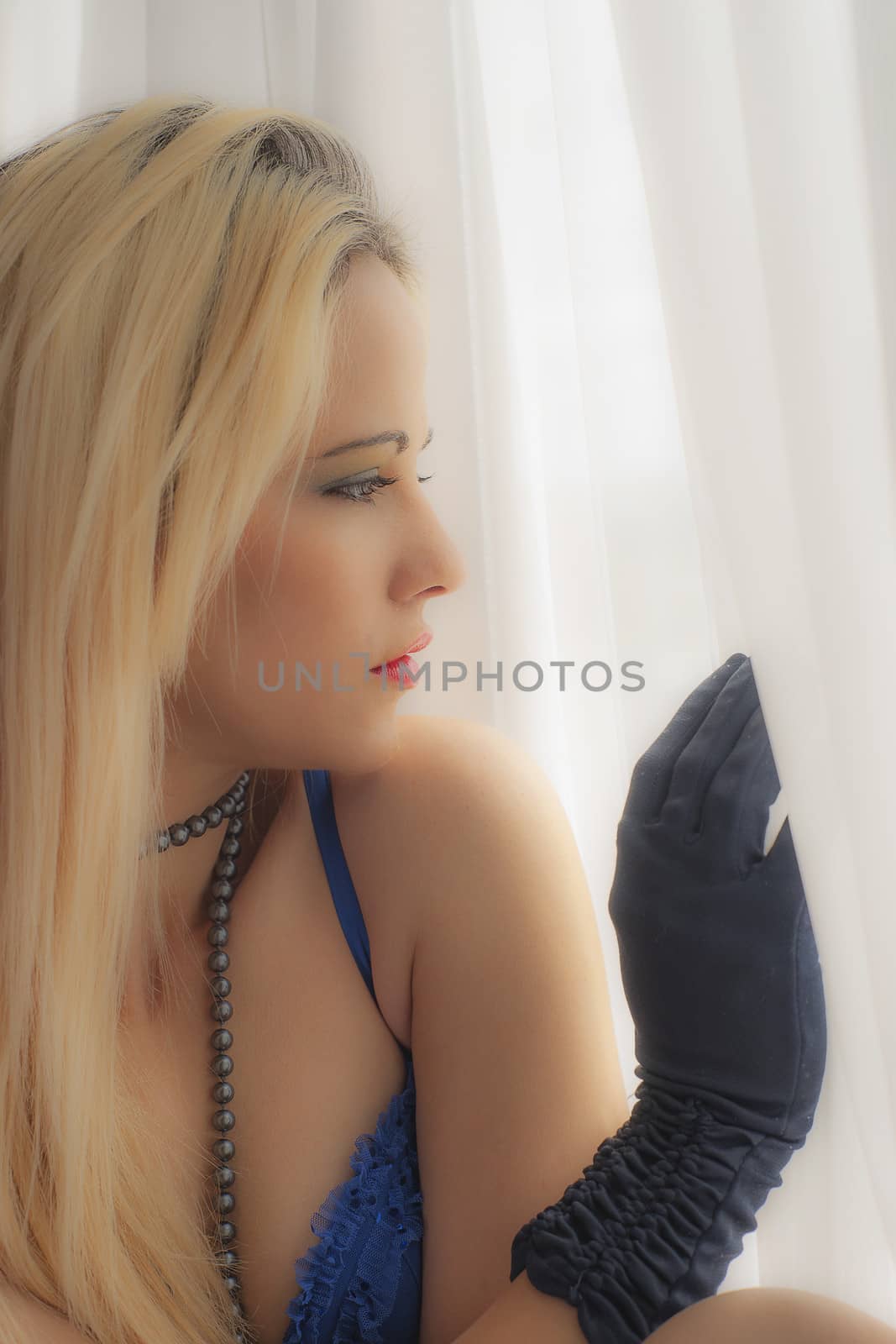 attractive blonde woman gazing out of  window