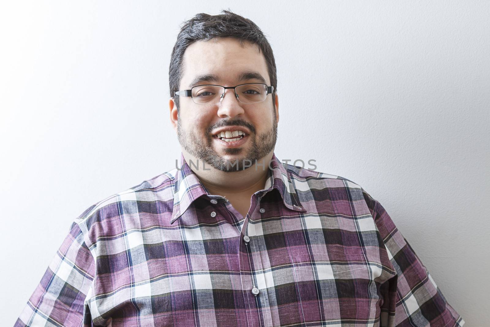 Young overweight man with happy expression