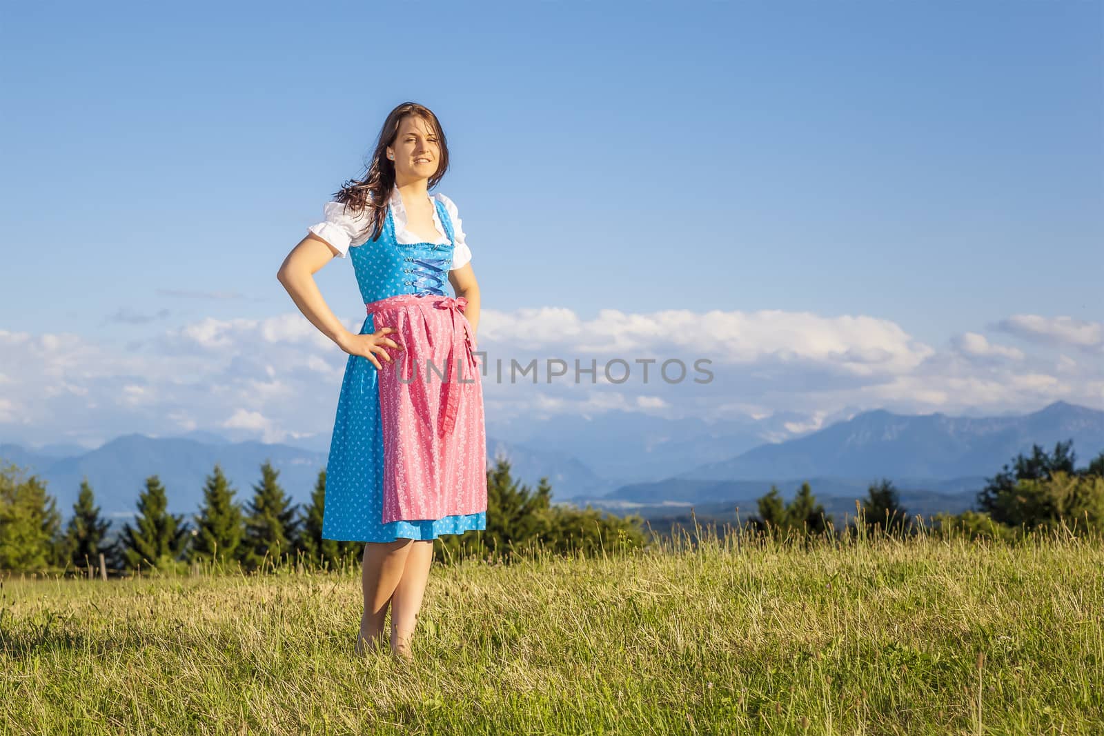 A woman in bavarian traditional dirndl in the nature