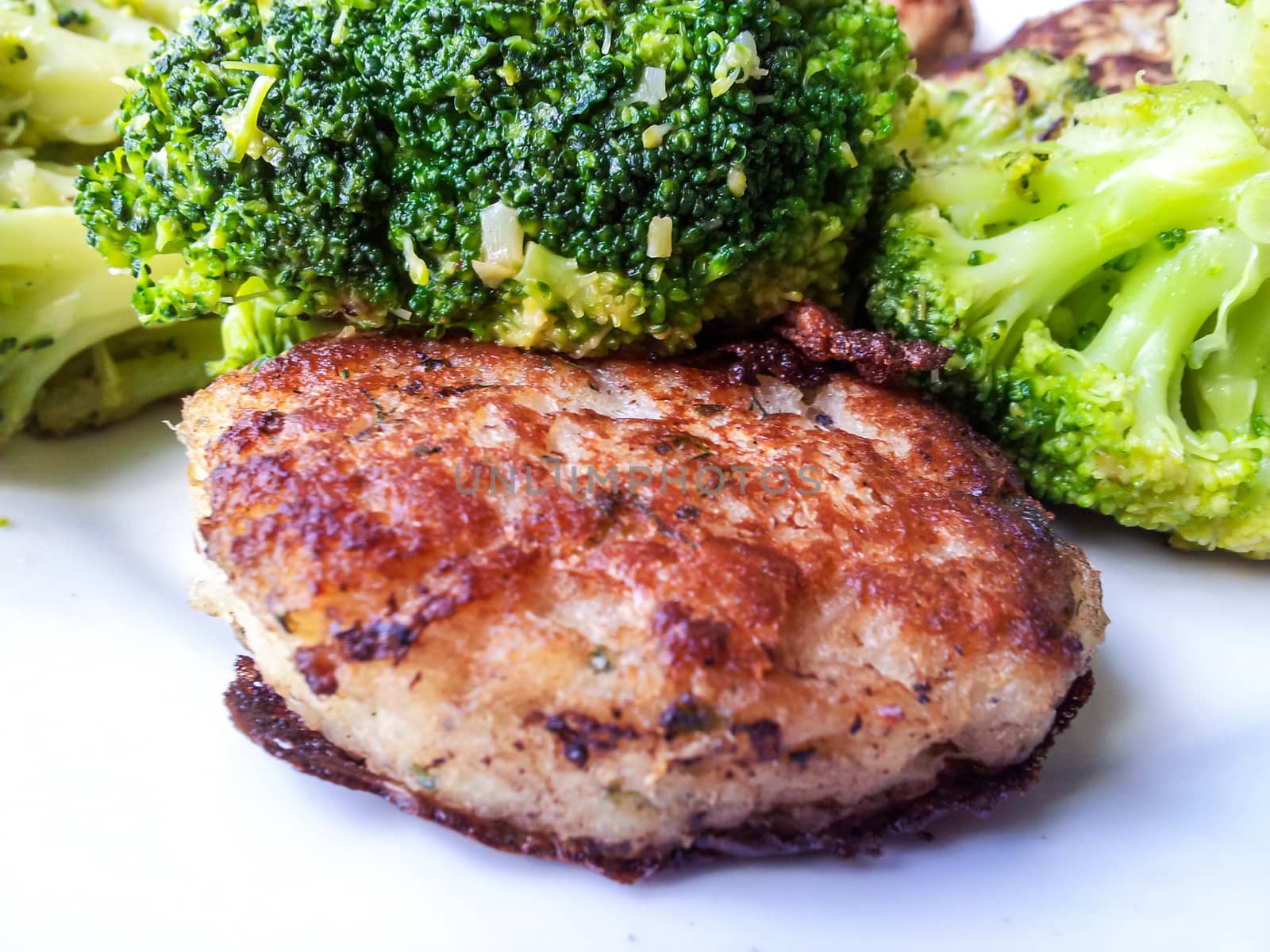 Fresh white fish cake, with beautiful broccoli on the side